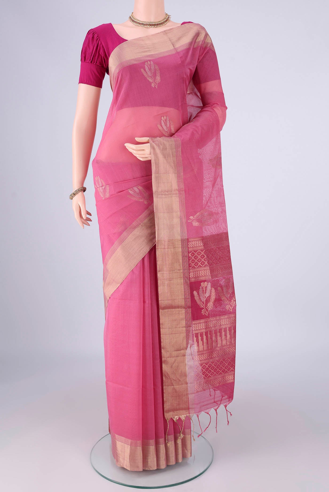 Pink Silk Cotton Saree with Zari Butta on the body and Zari Border.  displayed on a mannequin