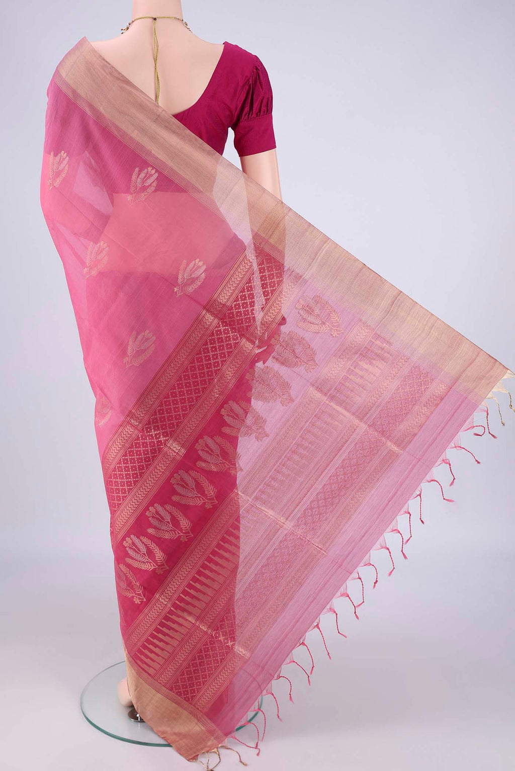 Flat view of Pink Silk Cotton Saree with Zari Butta on the body and Zari Border. 