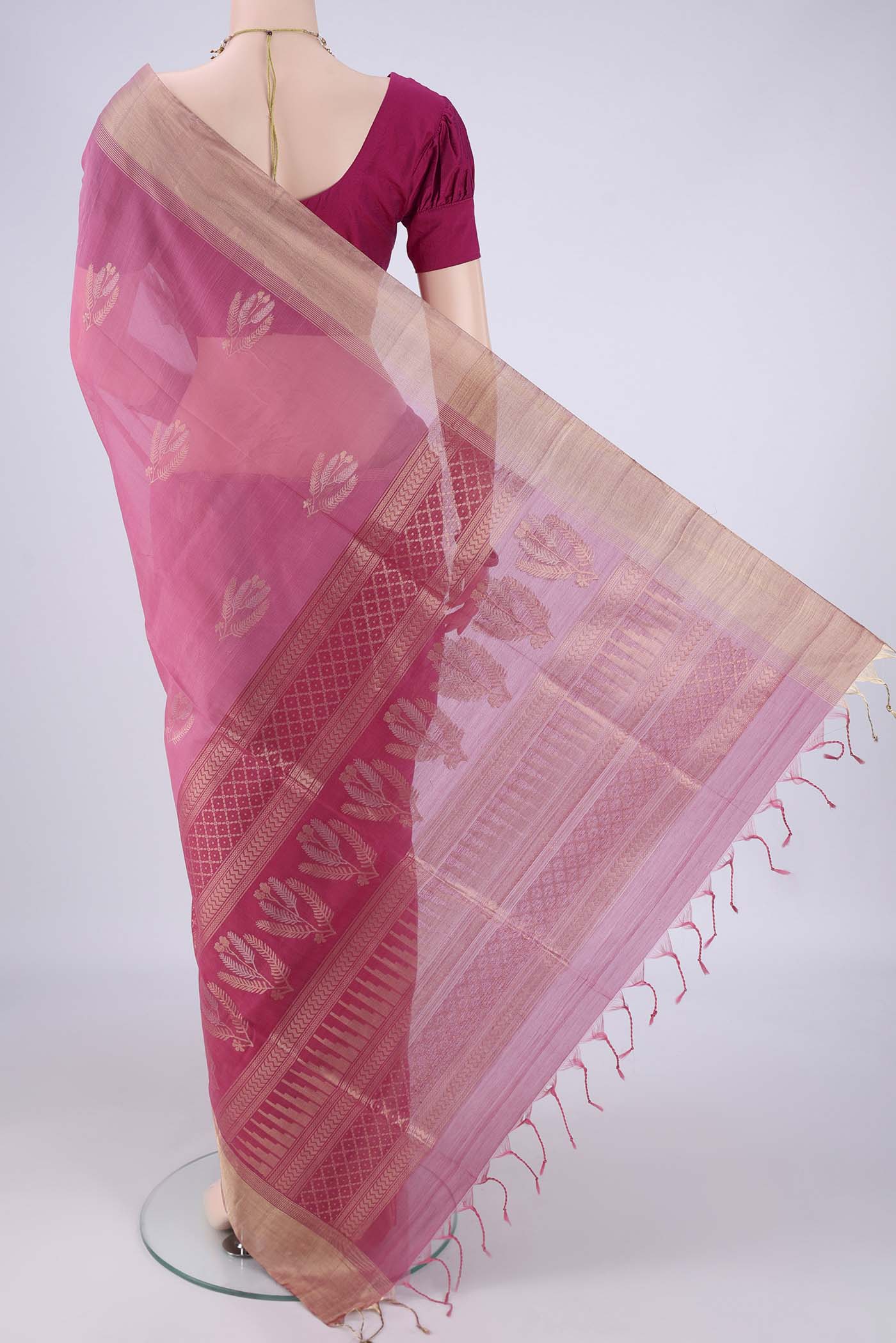 Flat view of Pink Silk Cotton Saree with Zari Butta on the body and Zari Border. 