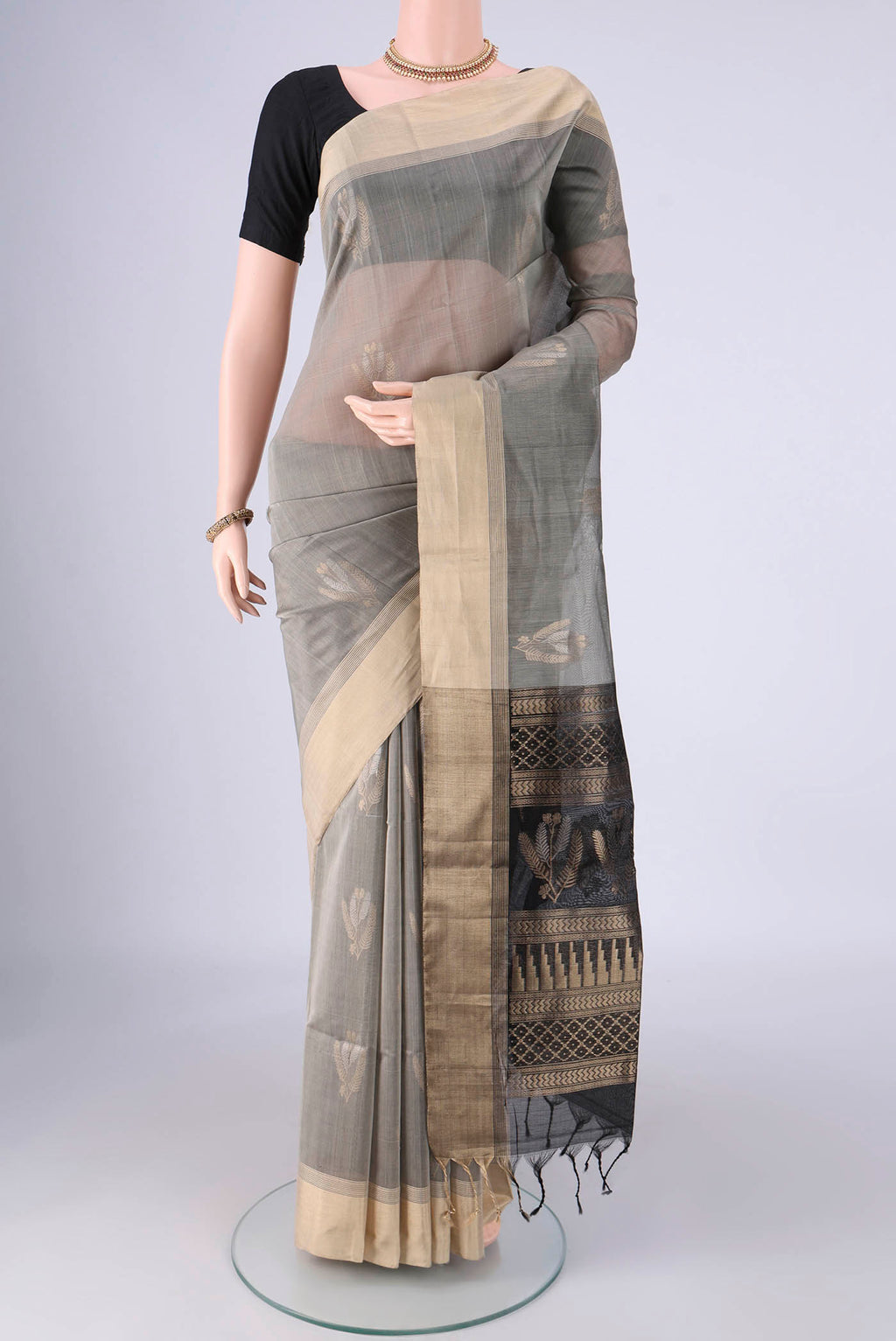 Grey Silk Cotton Saree with Zari Butta on the body and Zari Border.  displayed on a mannequin