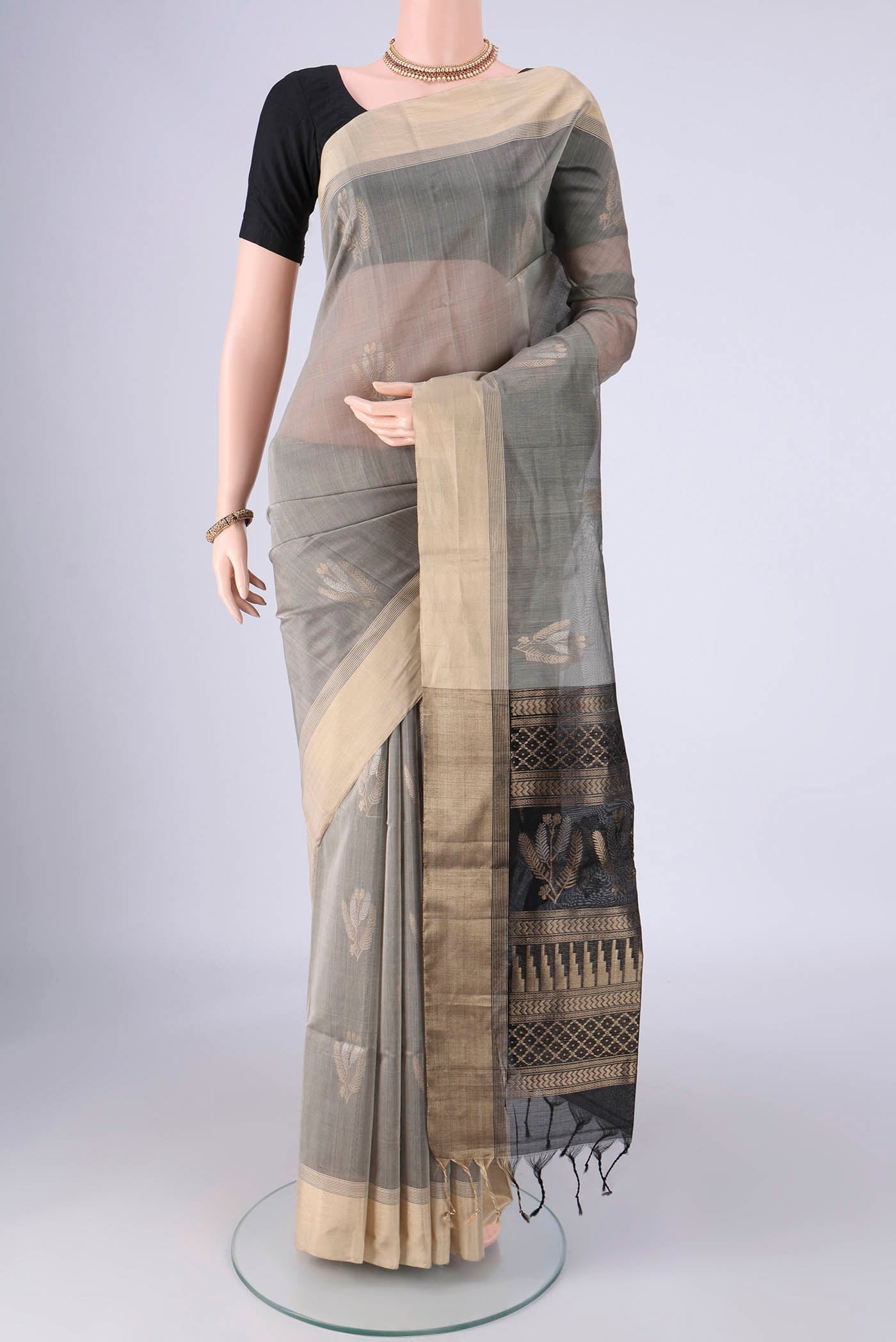 Grey Silk Cotton Saree with Zari Butta on the body and Zari Border.  displayed on a mannequin