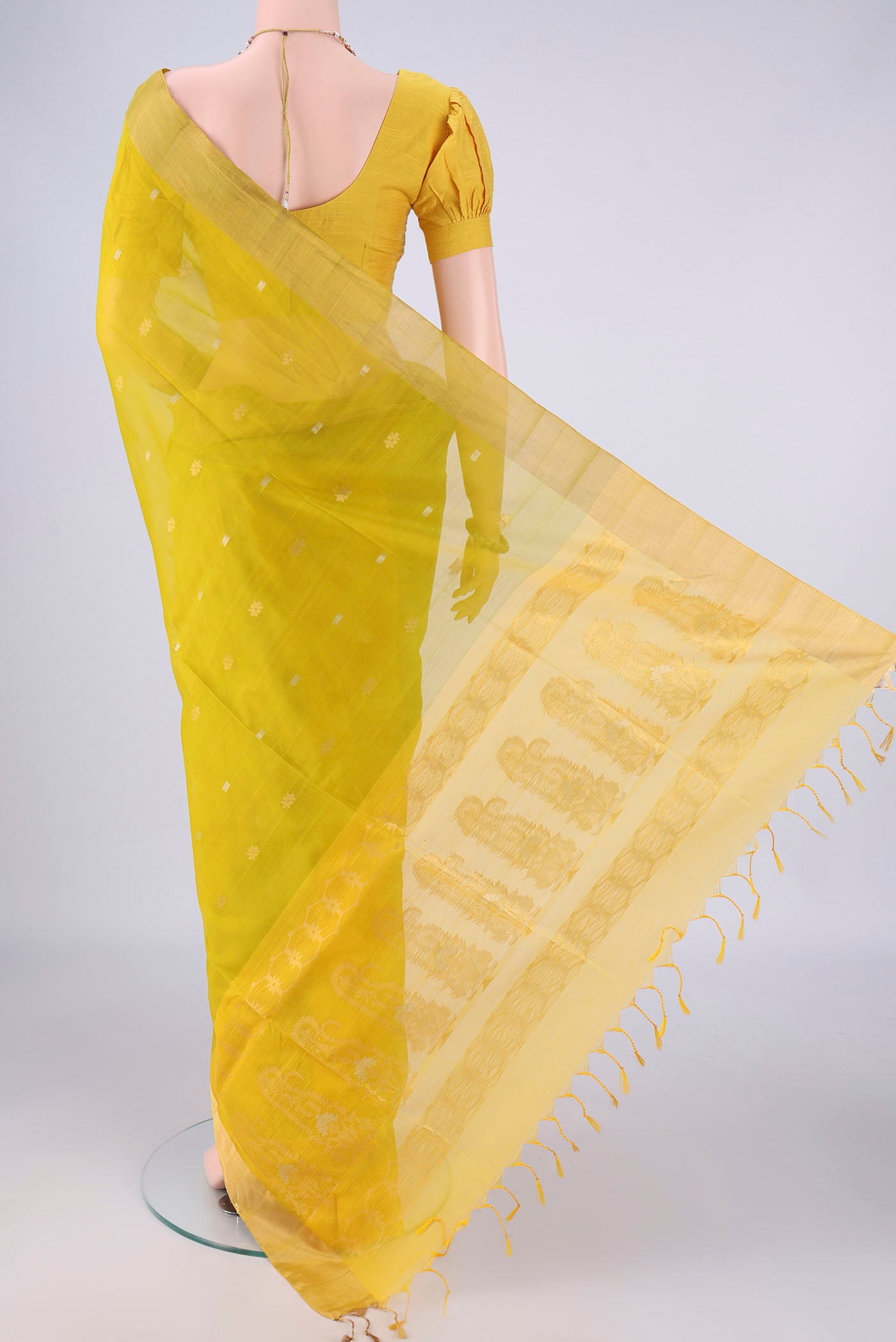 Flat view of Acid Green Silk Cotton Saree with Zari Butta on the body and Zari Border. 