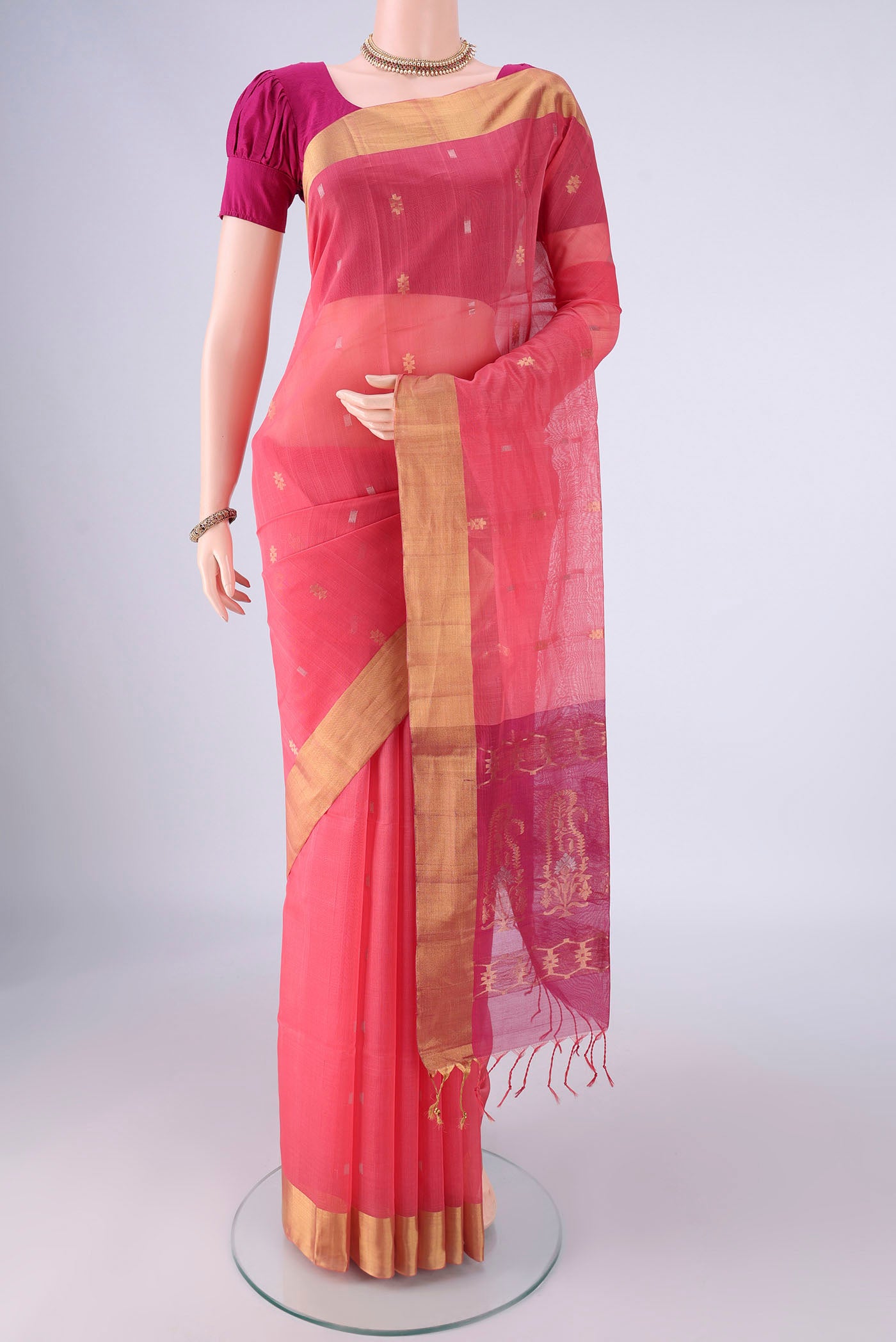 Rose pink Silk Cotton Saree with Zari Butta on the body and Zari Border.  displayed on a mannequin