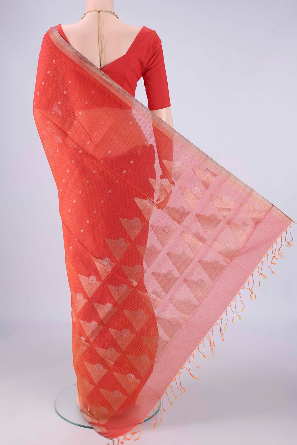 Flat view of Orange Silk Cotton Saree with Zari Butta on the body and Zari Border. 