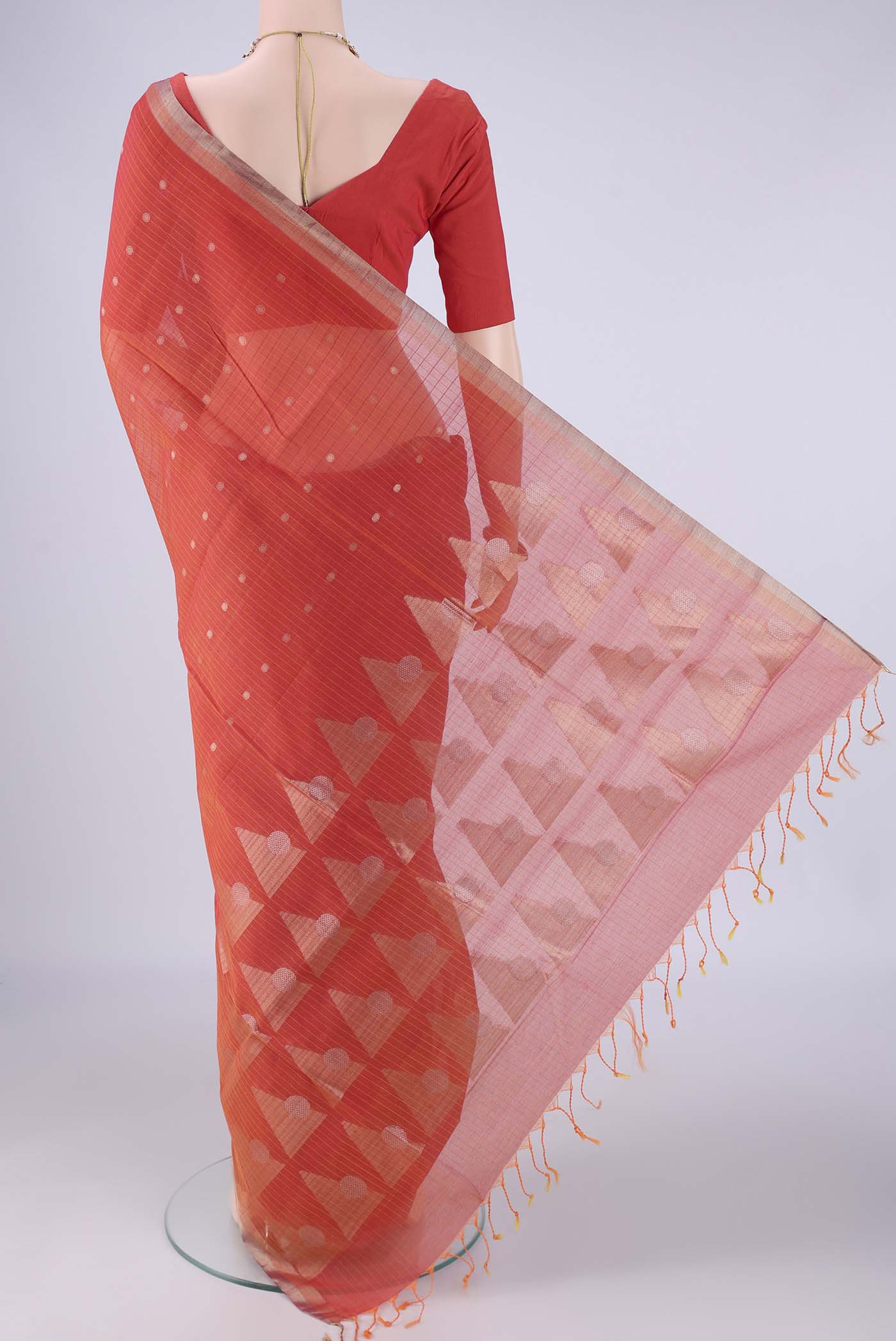 Flat view of Orange Silk Cotton Saree with Zari Butta on the body and Zari Border. 