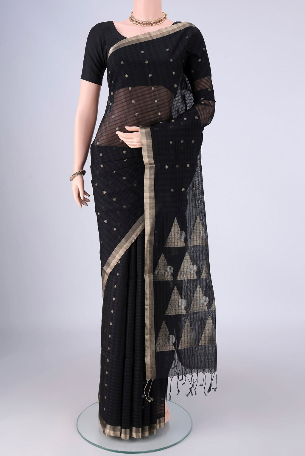 Black Silk Cotton Saree with Zari Butta on the body and Zari Border.  displayed on a mannequin