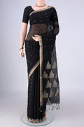 Black Silk Cotton Saree with Zari Butta on the body and Zari Border.  displayed on a mannequin