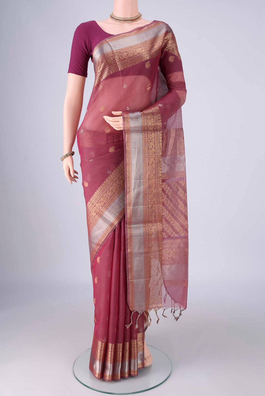 Light Magenta Silk Cotton Saree with Zari Butta on the body and Zari Border.  displayed on a mannequin