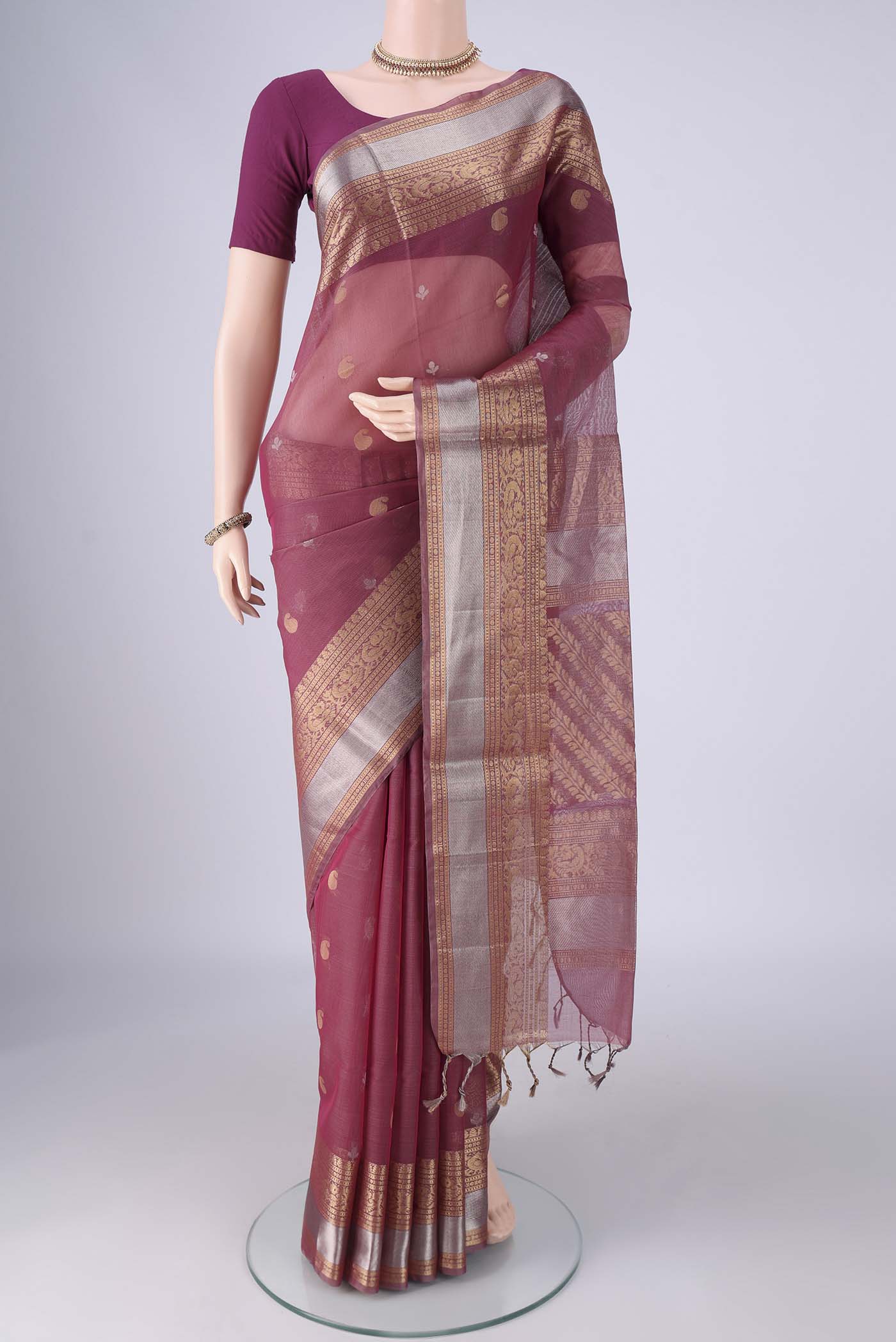 Light Magenta Silk Cotton Saree with Zari Butta on the body and Zari Border.  displayed on a mannequin
