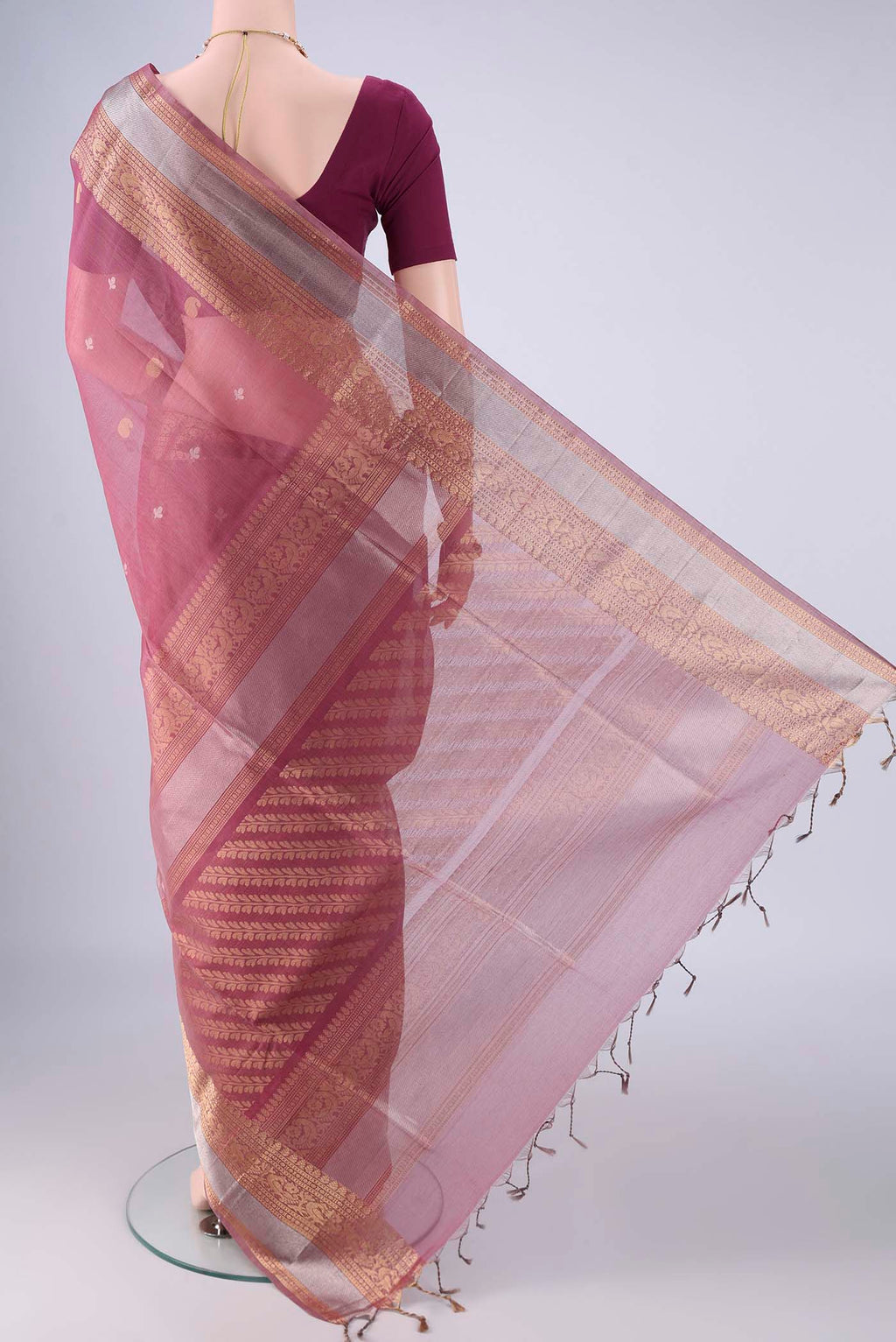 Flat view of Light Magenta Silk Cotton Saree with Zari Butta on the body and Zari Border. 