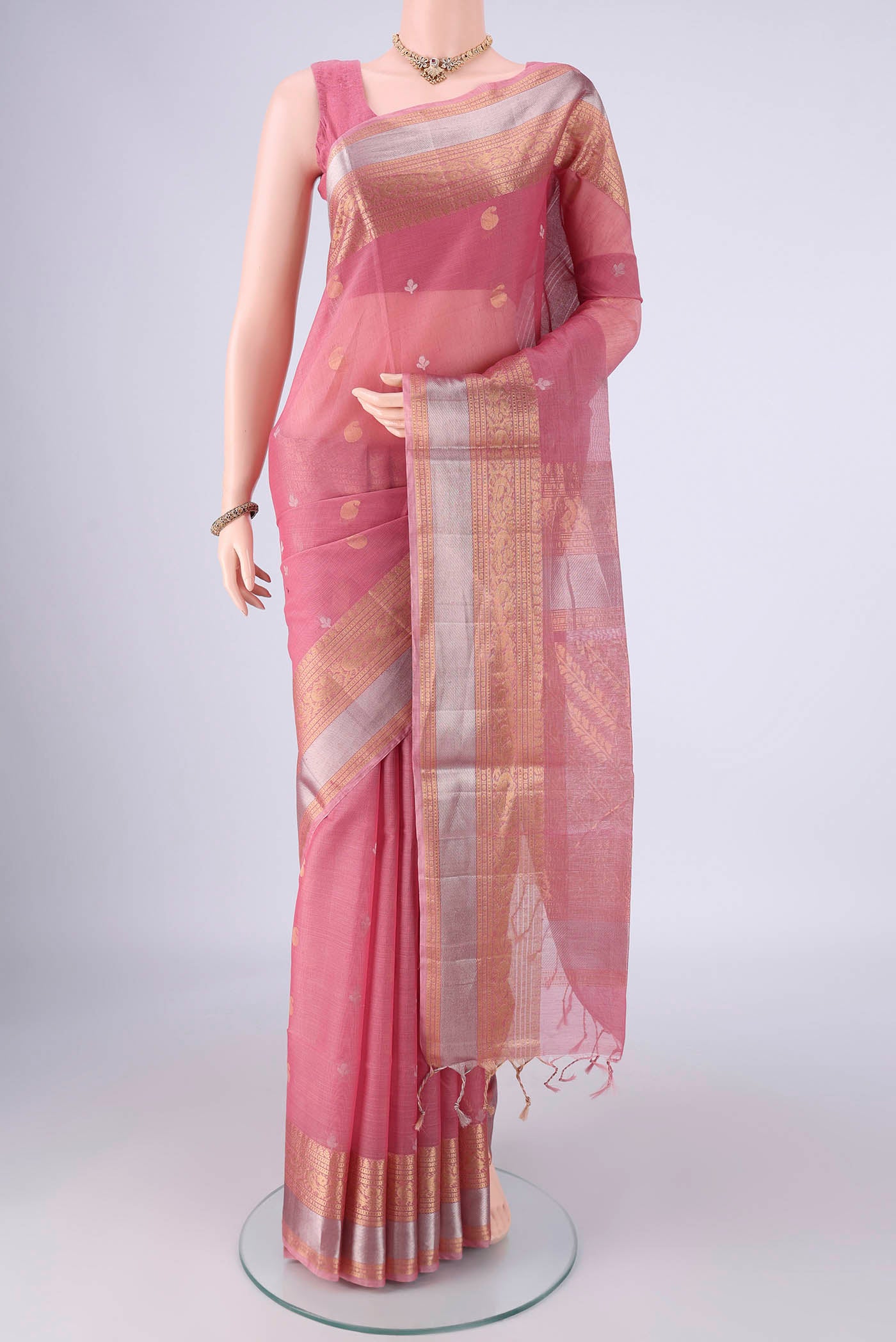 Rose pink Silk Cotton Saree with Zari Butta on the body and Zari Border.  displayed on a mannequin