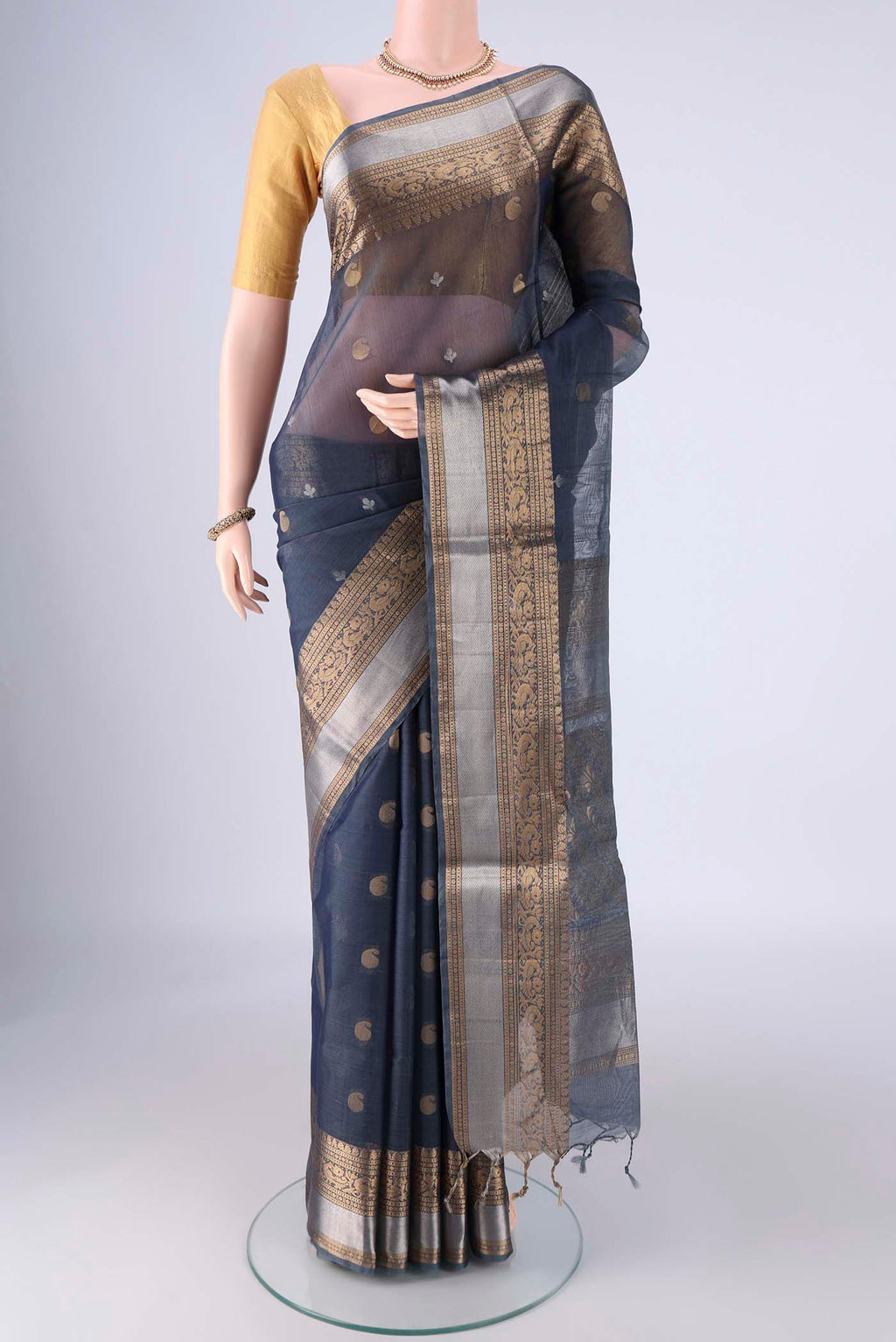 Blue Grey Silk Cotton Saree with Zari Butta on the body and Zari Border.  displayed on a mannequin