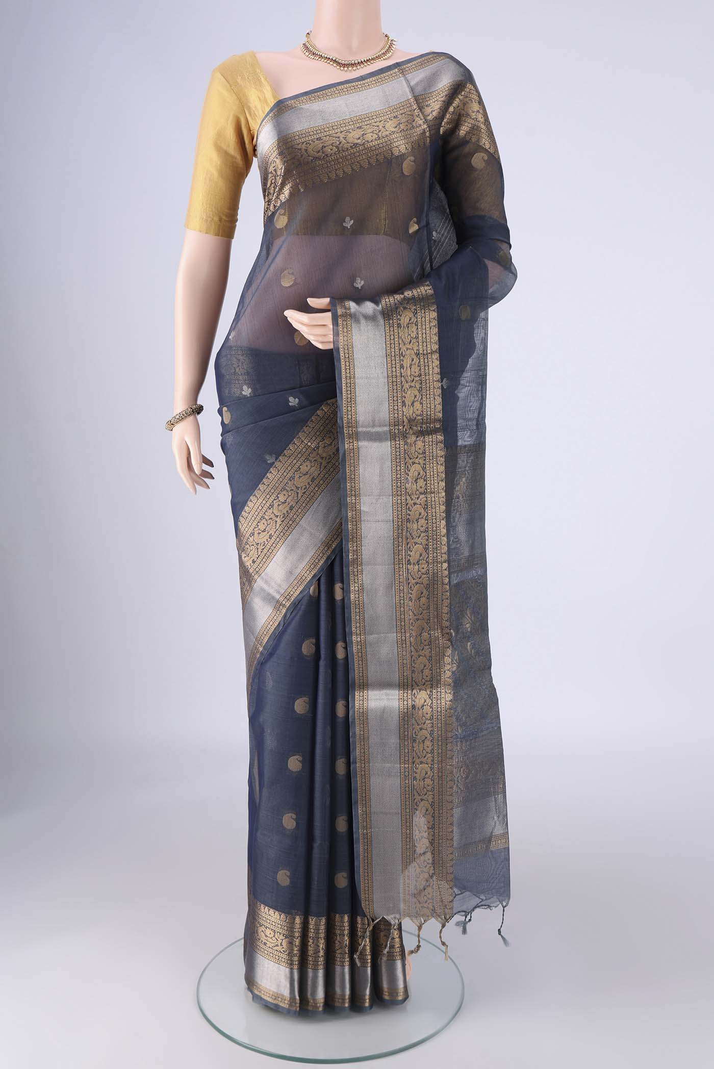 Blue Grey Silk Cotton Saree with Zari Butta on the body and Zari Border.  displayed on a mannequin