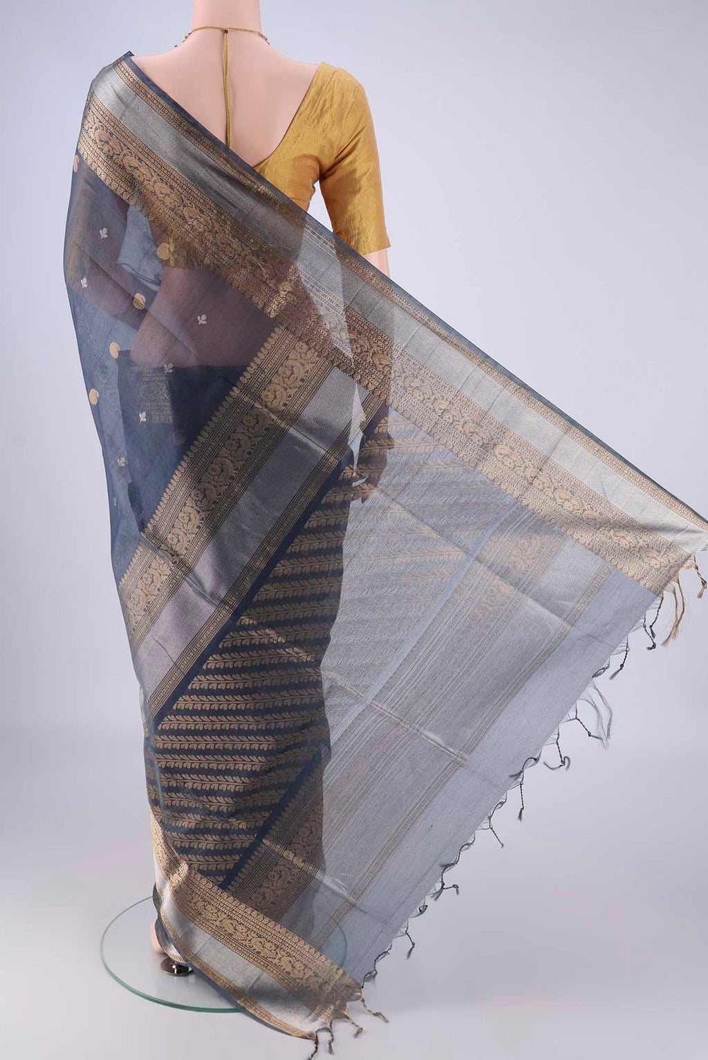 Flat view of Blue Grey Silk Cotton Saree with Zari Butta on the body and Zari Border. 