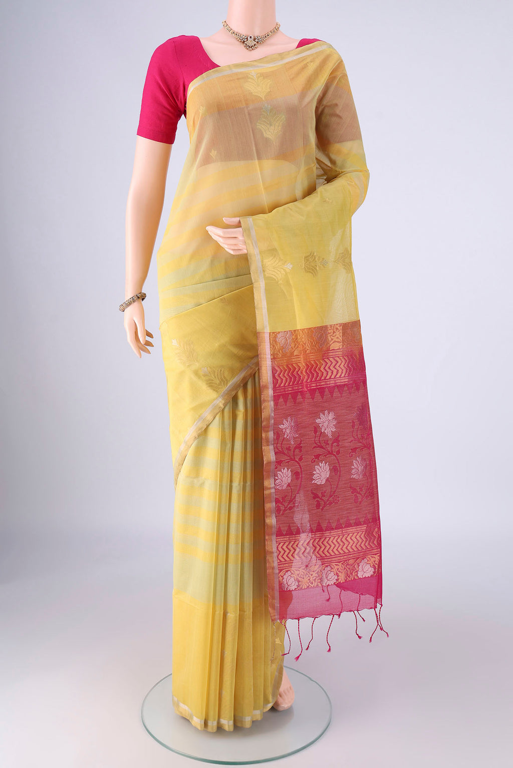 Yellow Silk Cotton Saree with Stripes on the body and Zari Border.  displayed on a mannequin