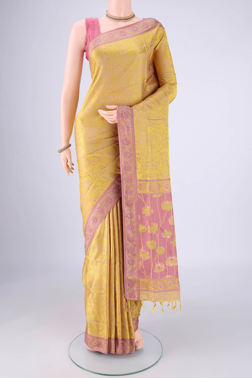 Yellow Soft Silk Saree with Jacquard design on the body and Thread Border.  displayed on a mannequin