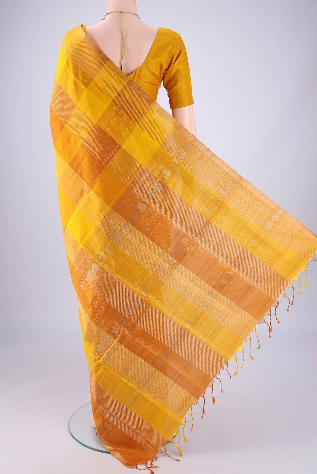 Flat view of Mustard Soft Silk Saree with Checked design on the body and Zari Border. 