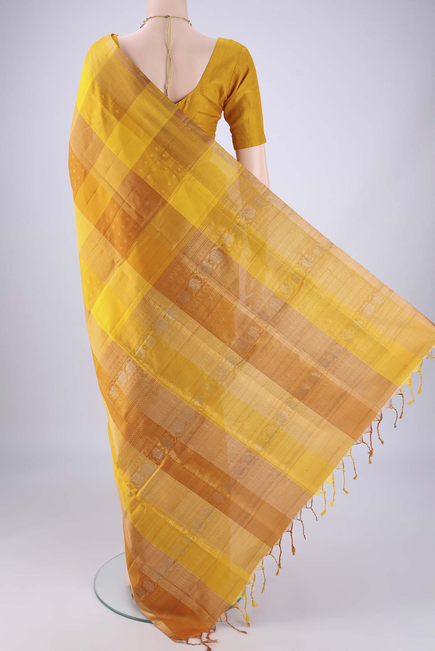Flat view of Mustard Soft Silk Saree with Checked design on the body and Zari Border. 
