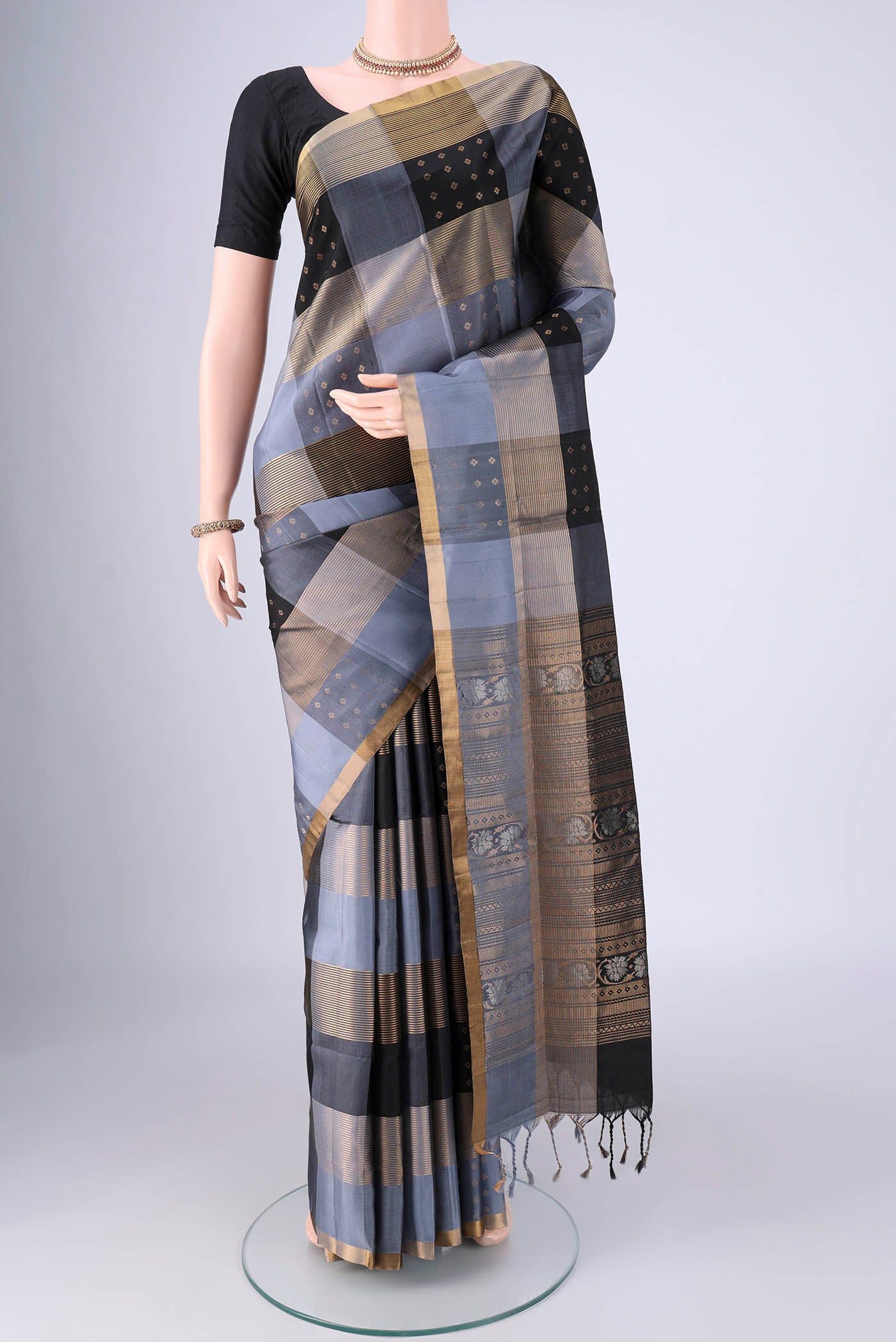Multi Color Soft Silk Saree with Checked design on the body and Zari Border.  displayed on a mannequin