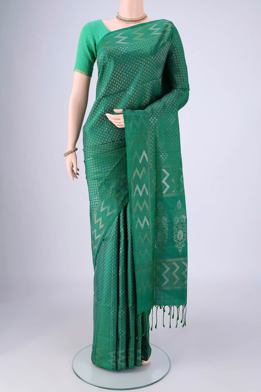 Green Soft Silk Saree with Zari Brocade on the body and Zari Border.  displayed on a mannequin