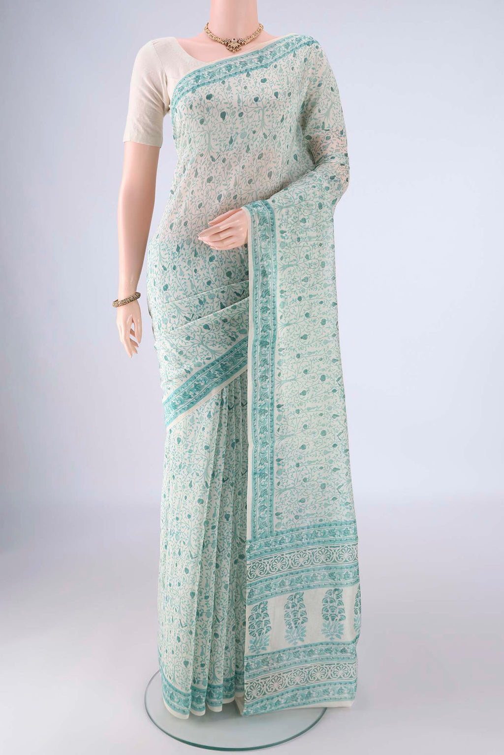 Off White Chanderi Silk Cotton Saree with Floral Print on the body and Printed Border.  displayed on a mannequin
