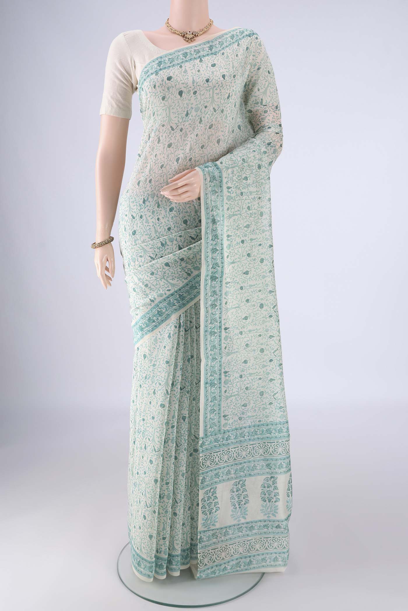 Off White Chanderi Silk Cotton Saree with Floral Print on the body and Printed Border.  displayed on a mannequin