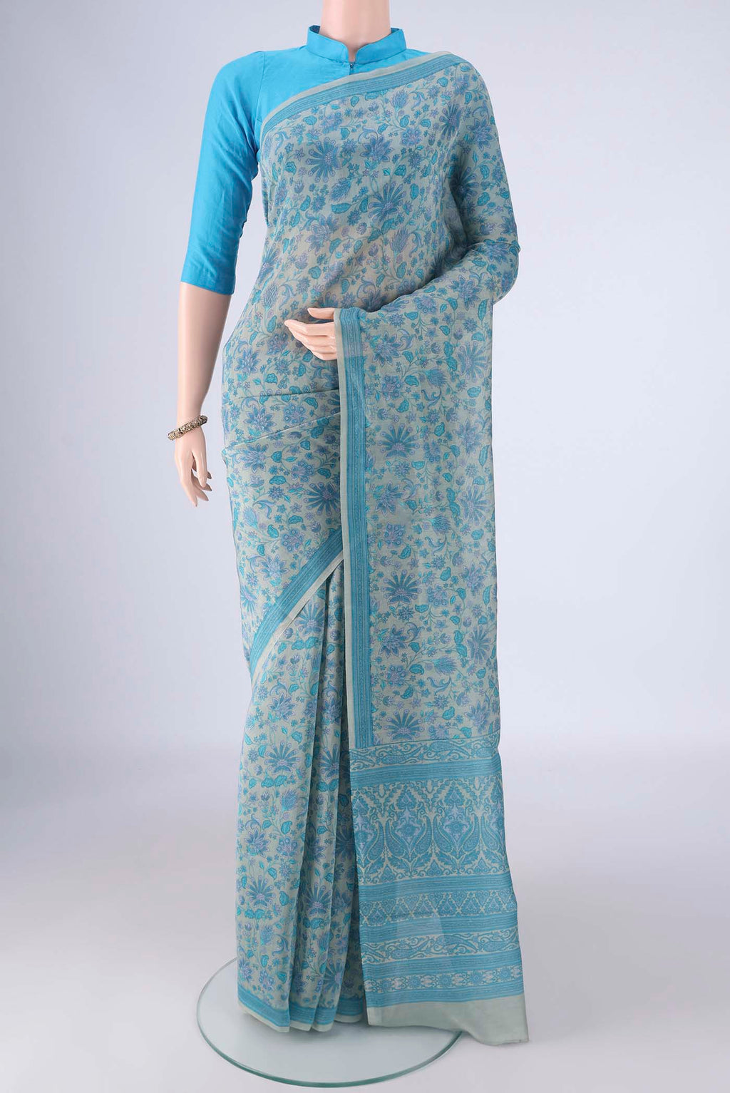 Blue Grey Chanderi Silk Cotton Saree with Floral Print on the body and Printed Border.  displayed on a mannequin