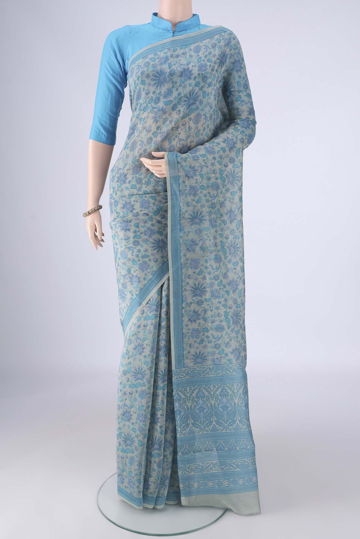 Blue Grey Chanderi Silk Cotton Saree with Floral Print on the body and Printed Border.  displayed on a mannequin