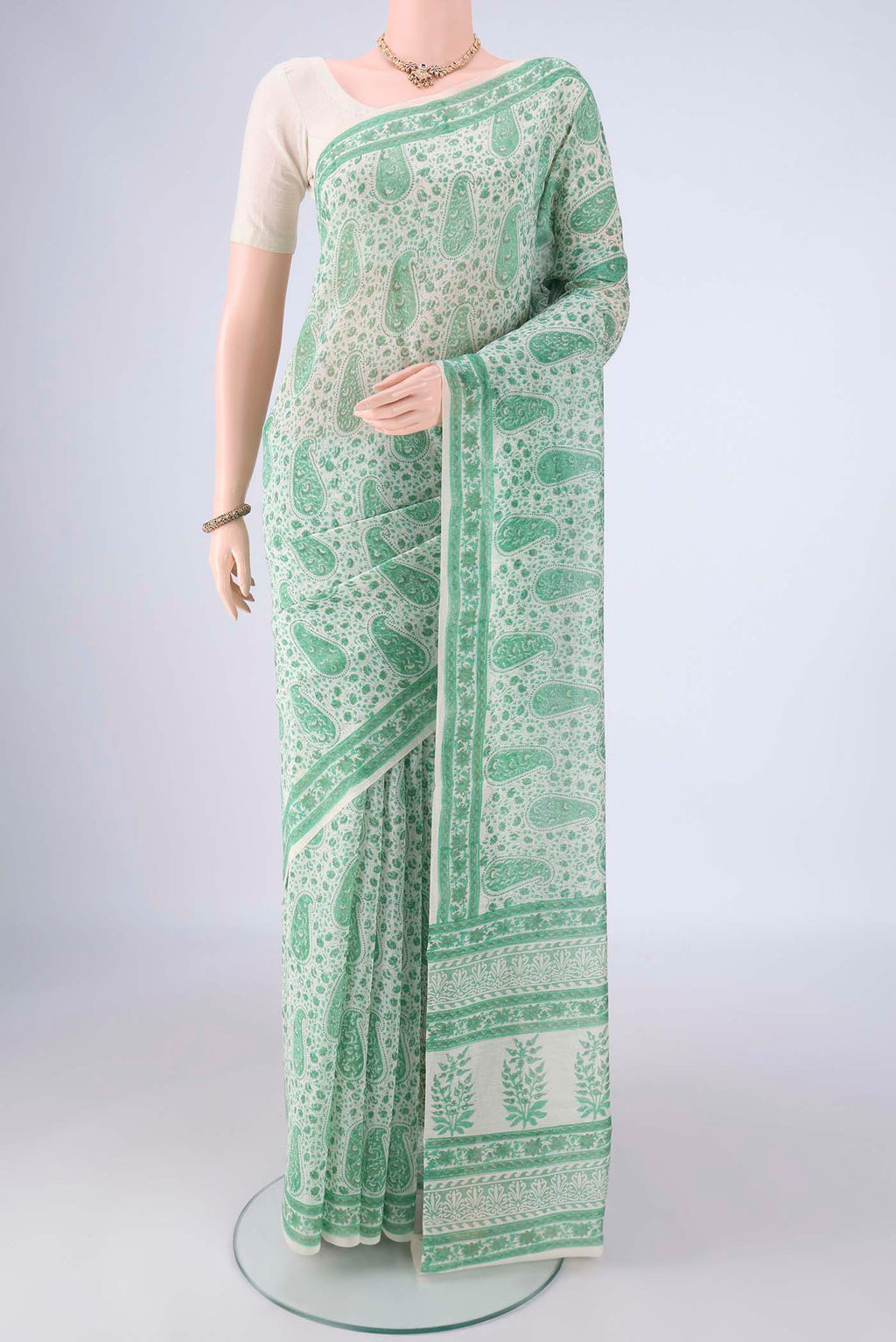 Off White Chanderi Silk Cotton Saree with Floral Print on the body and Printed Border.  displayed on a mannequin