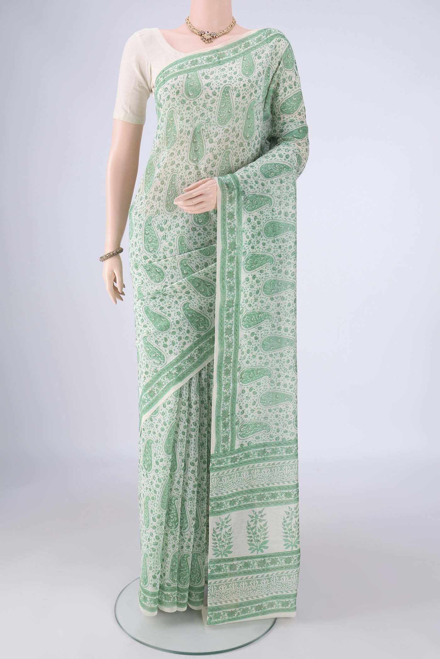 Off White Chanderi Silk Cotton Saree with Floral Print on the body and Printed Border.  displayed on a mannequin