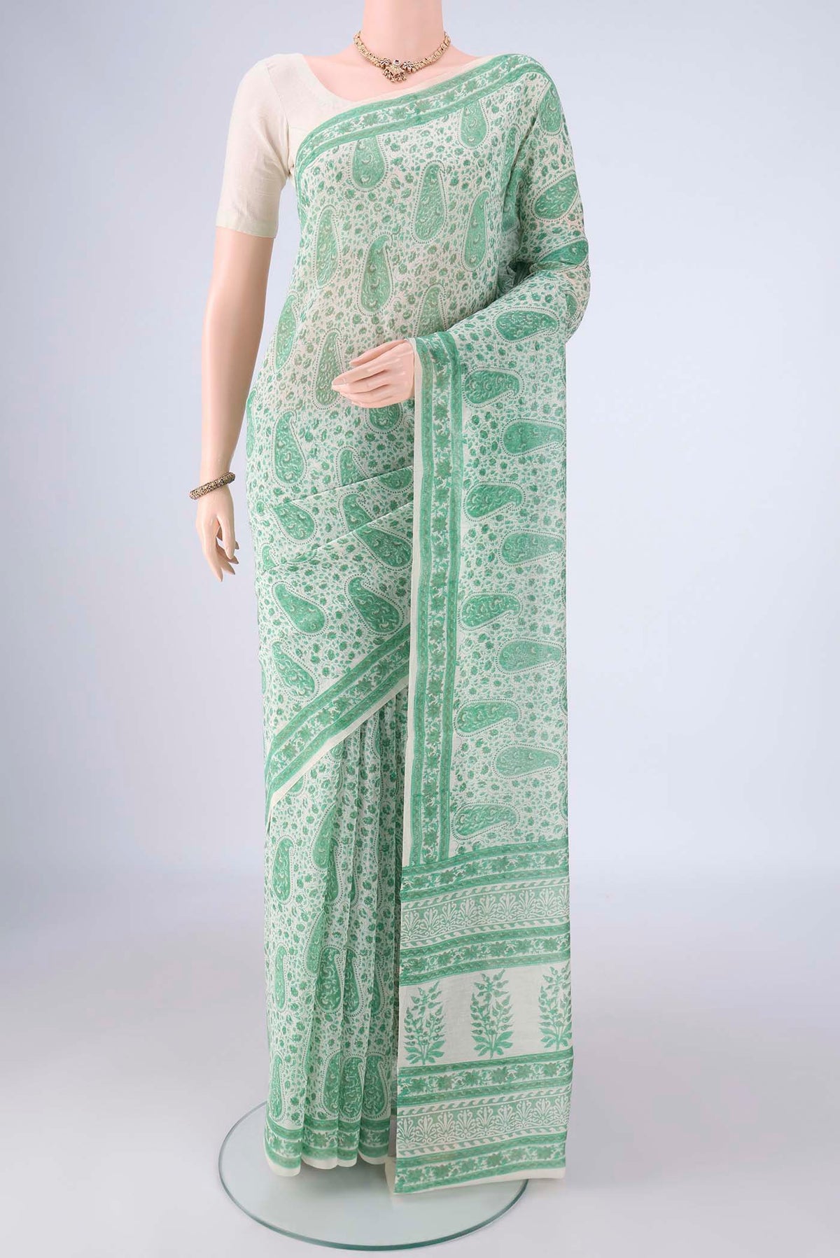 Off White Chanderi Silk Cotton Saree with Floral Print on the body and Printed Border.  displayed on a mannequin