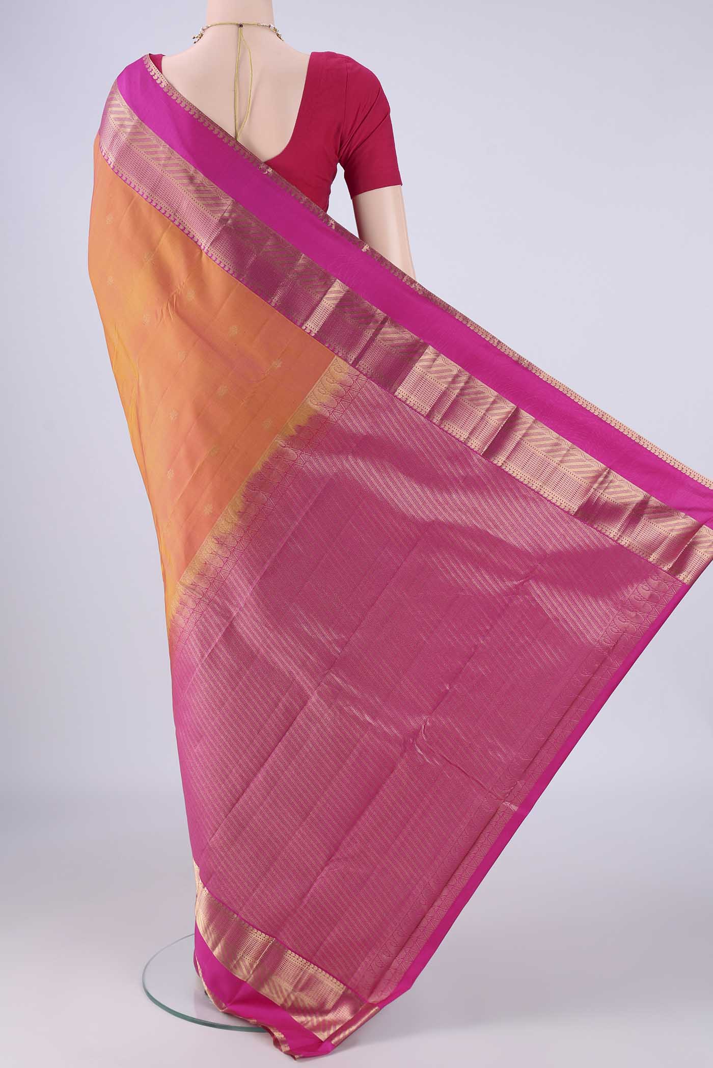 Flat view of Pinkish Yellow Dual Tone Kanchipuram Silk Saree with Zari Butta on the body and Zari Border. 