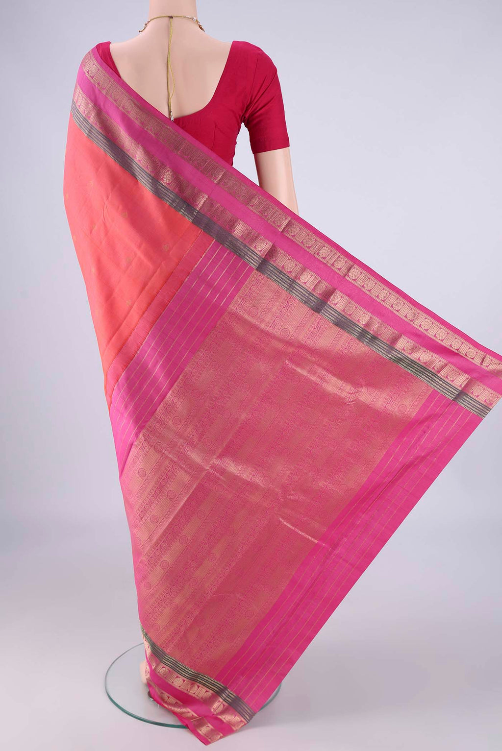 Flat view of Coral Kanchipuram Silk Saree with Zari Butta on the body and Zari Border. 