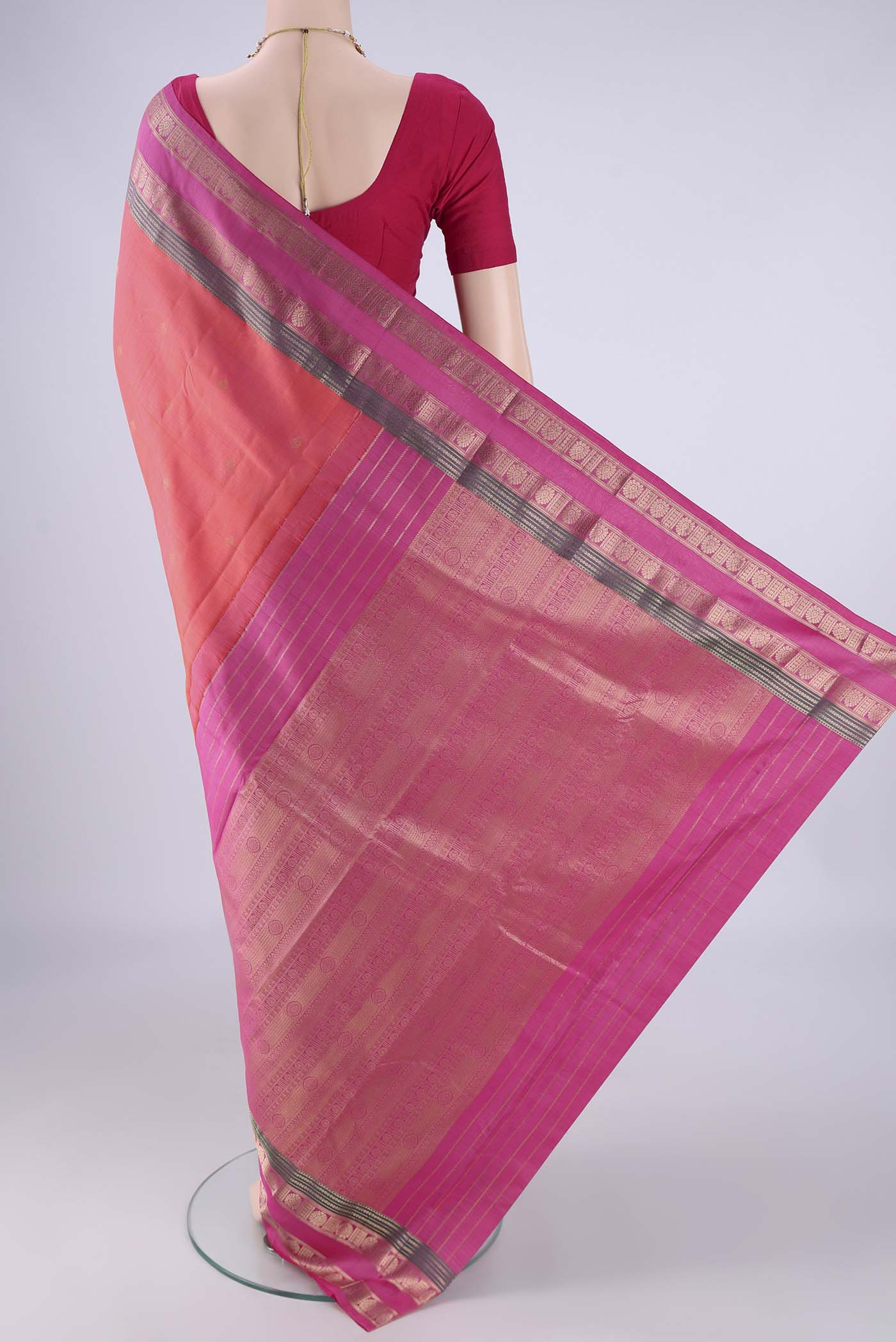 Flat view of Coral Kanchipuram Silk Saree with Zari Butta on the body and Zari Border. 
