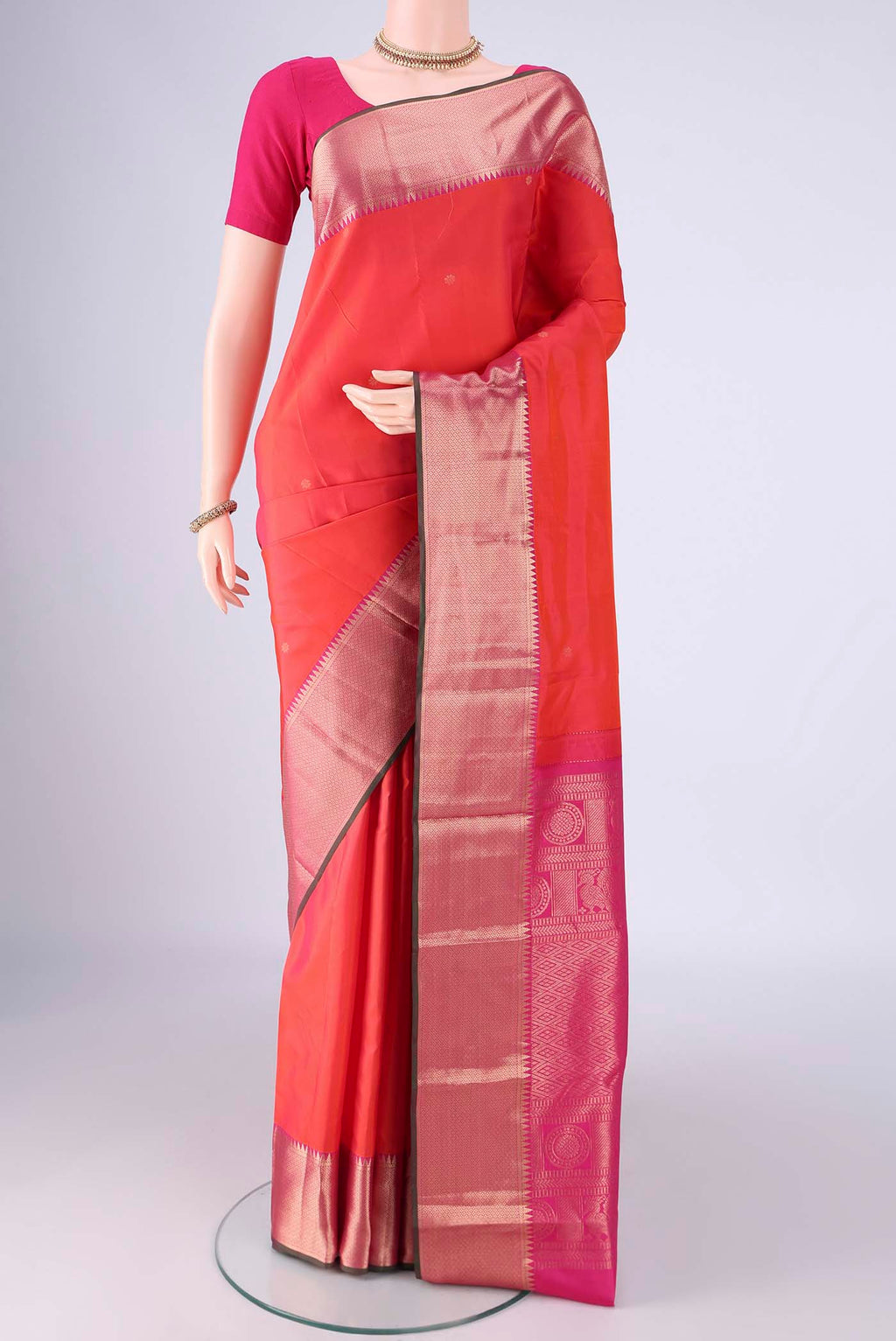 Coral Dual Tone Kanchipuram Silk Saree with Zari Butta on the body and Zari Border.  displayed on a mannequin