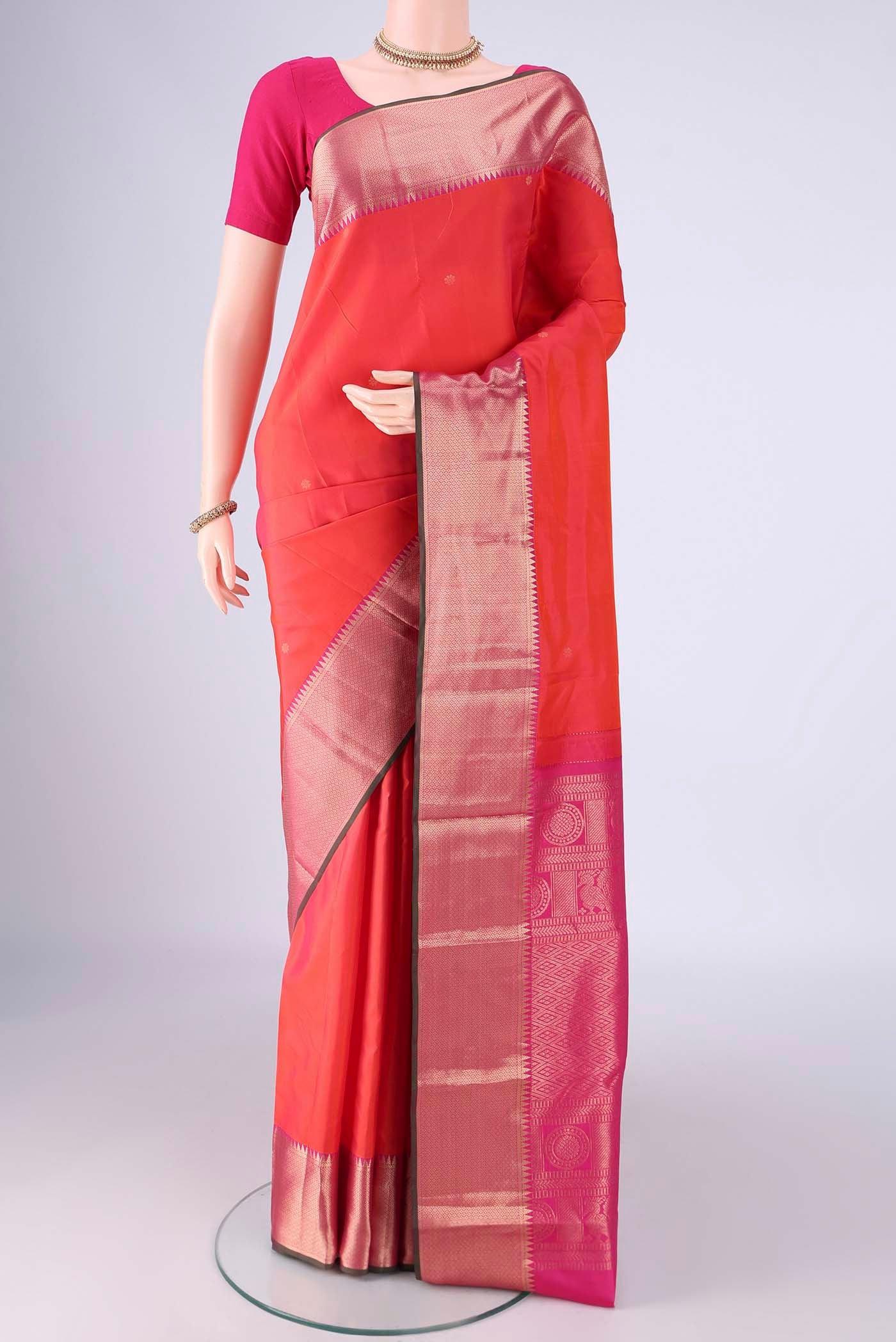 Coral Dual Tone Kanchipuram Silk Saree with Zari Butta on the body and Zari Border.  displayed on a mannequin