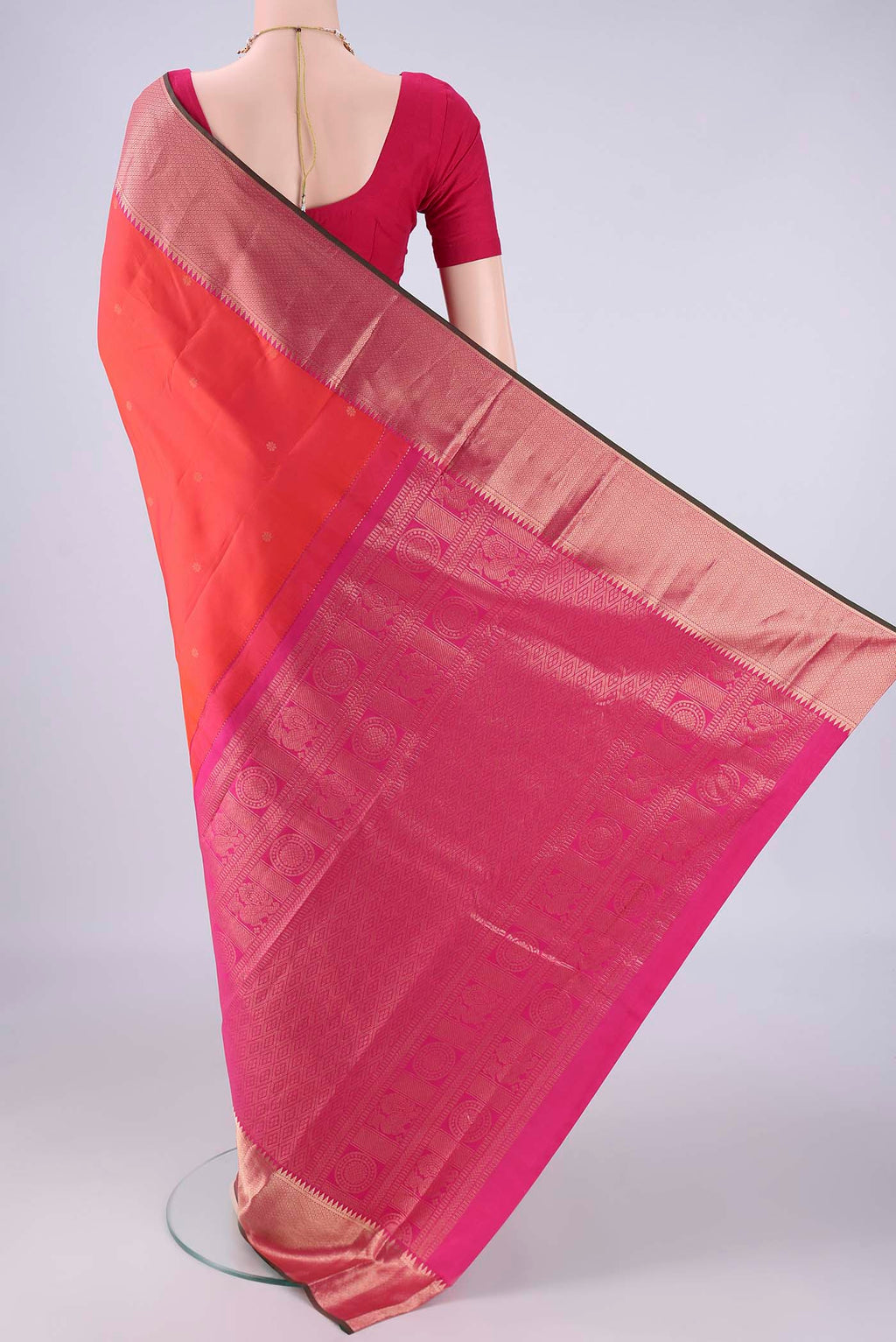 Flat view of Coral Dual Tone Kanchipuram Silk Saree with Zari Butta on the body and Zari Border. 