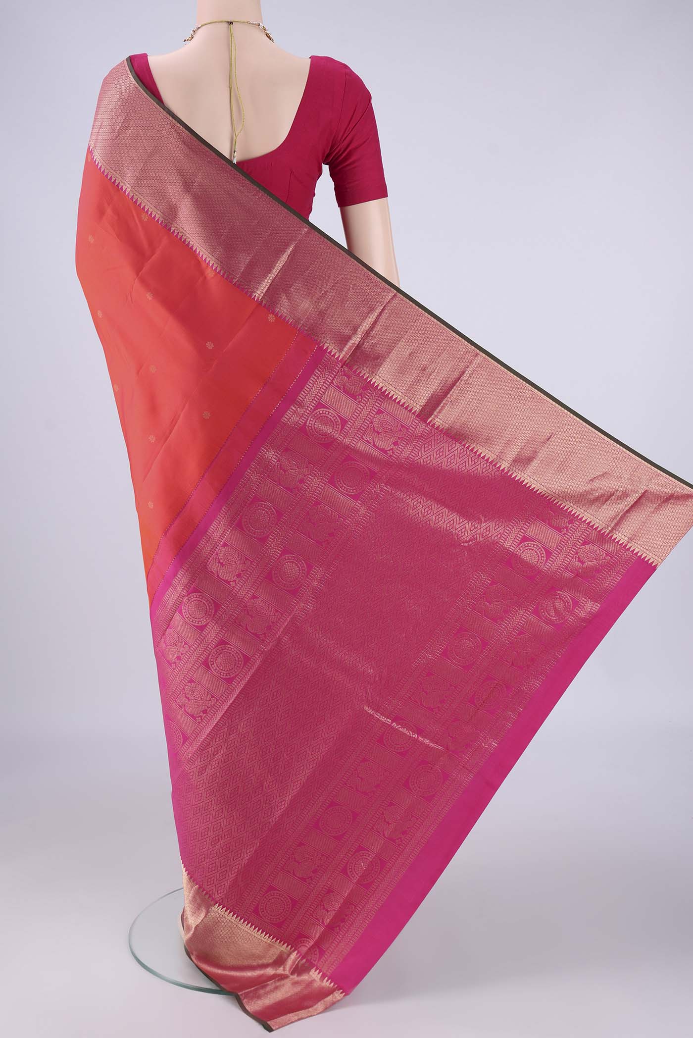 Flat view of Coral Dual Tone Kanchipuram Silk Saree with Zari Butta on the body and Zari Border. 