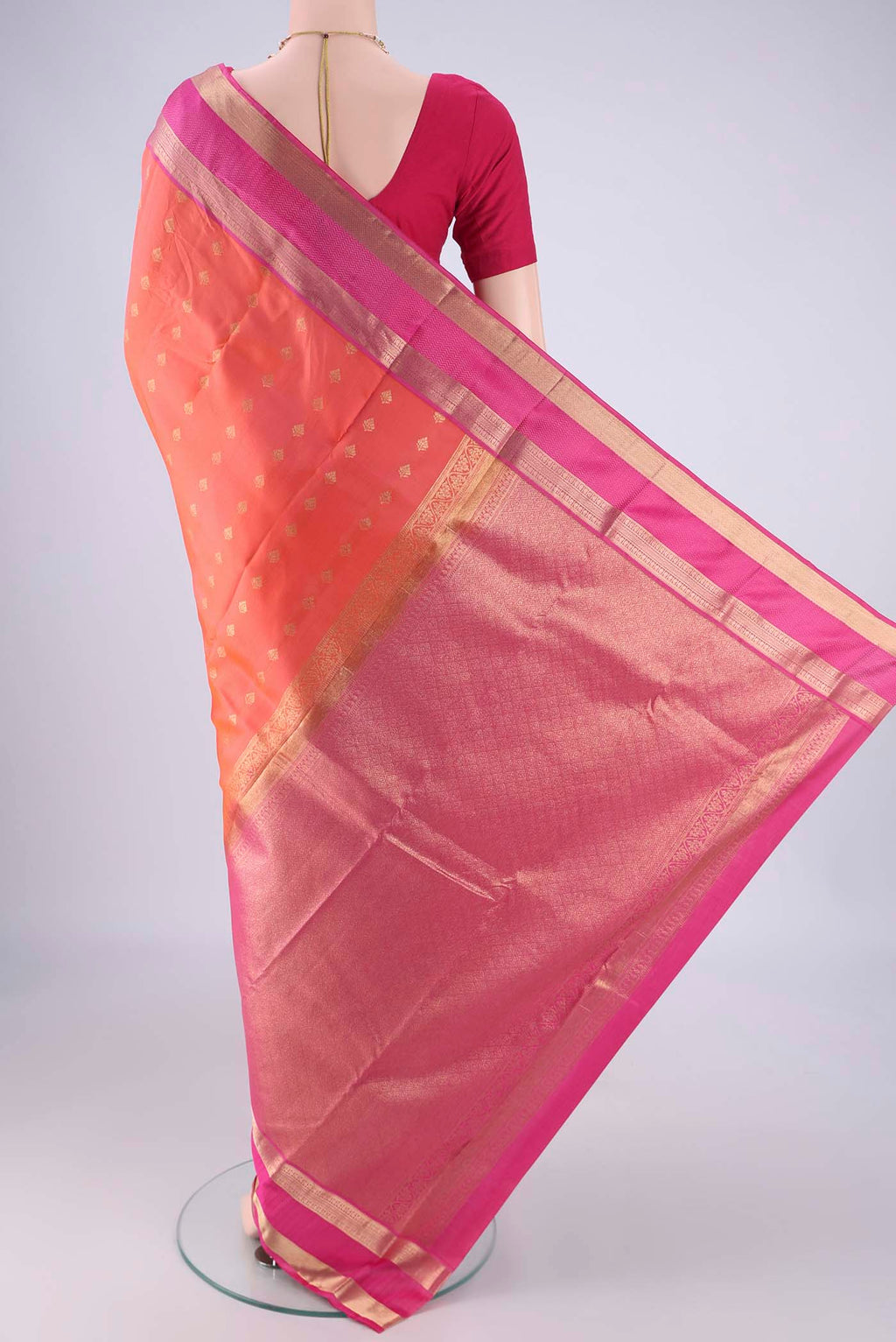 Flat view of Orange Kanchipuram Silk Saree with Zari Butta on the body and Zari Border. 