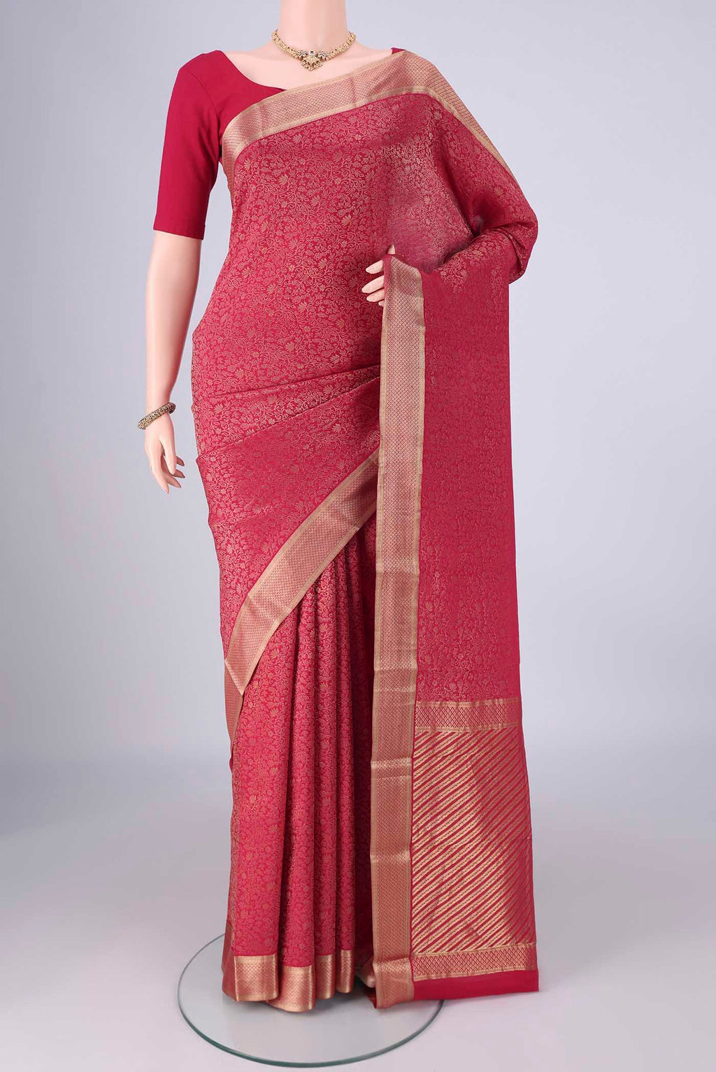Rani Pink Mysore Crepe Saree with Zari Brocade on the body and Zari Border.  displayed on a mannequin