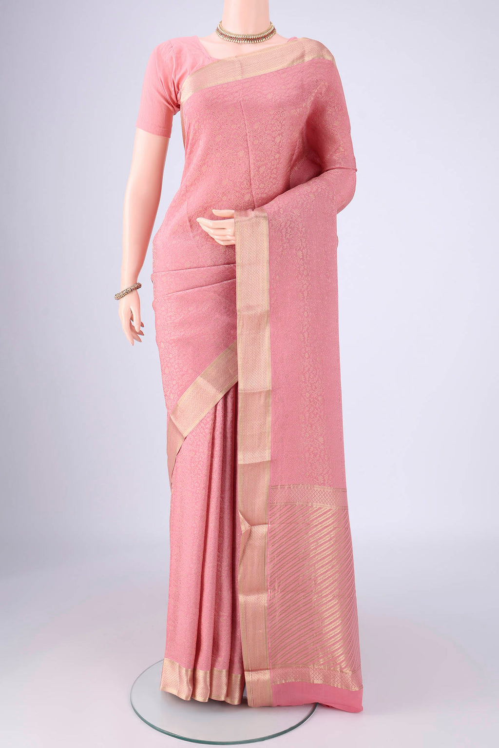 Rose pink Mysore Crepe Saree with Zari Brocade on the body and Zari Border.  displayed on a mannequin