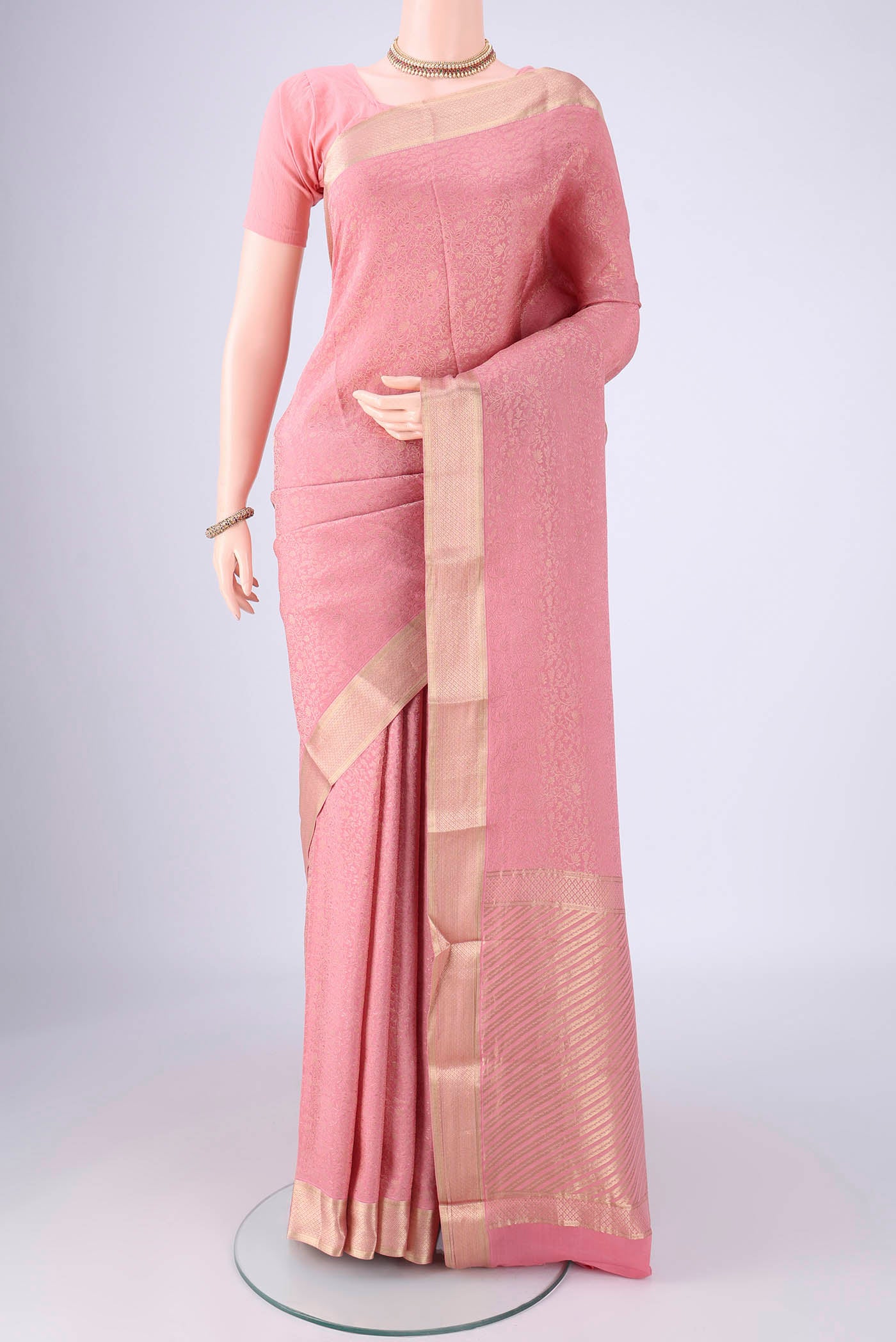 Rose pink Mysore Crepe Saree with Zari Brocade on the body and Zari Border.  displayed on a mannequin