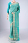 Turquoise Mysore Crepe Saree with Zari Brocade on the body and Zari Border.  displayed on a mannequin