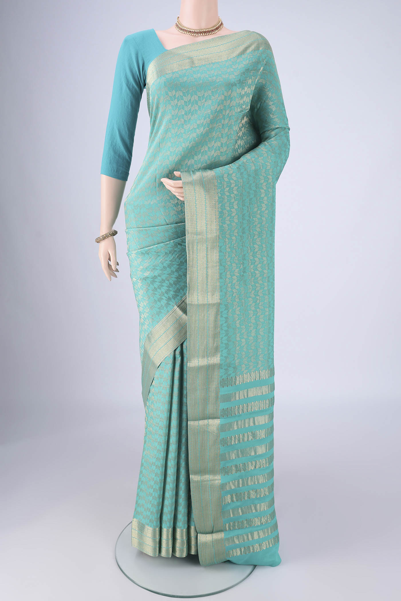 Turquoise Mysore Crepe Saree with Zari Brocade on the body and Zari Border.  displayed on a mannequin
