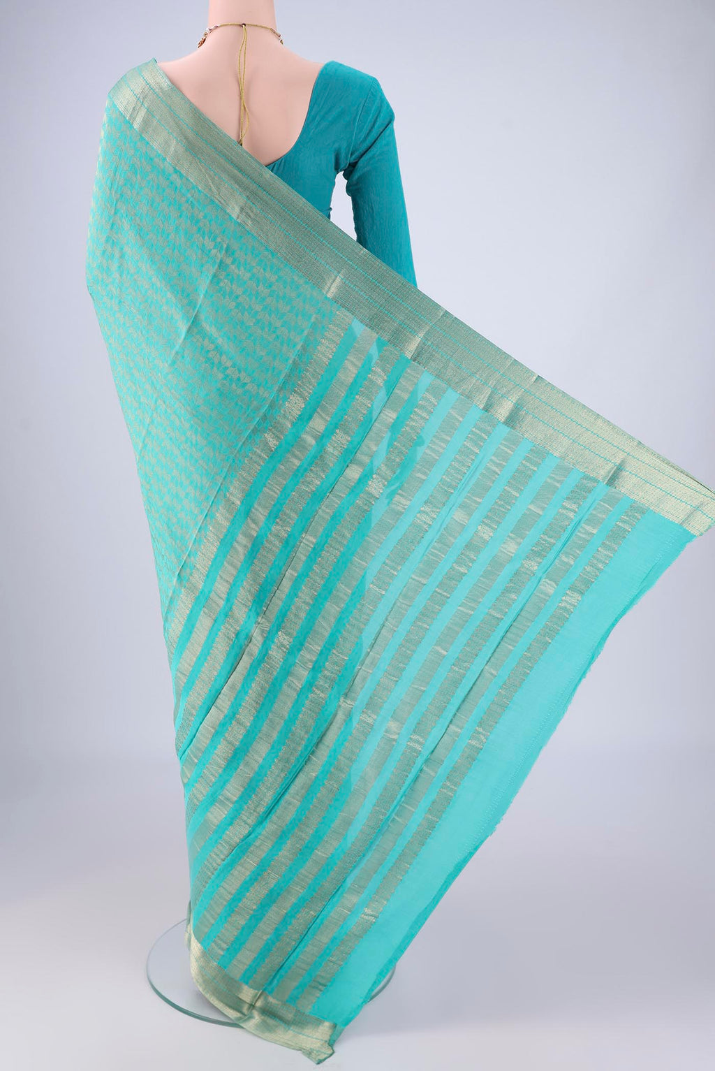 Flat view of Turquoise Mysore Crepe Saree with Zari Brocade on the body and Zari Border. 