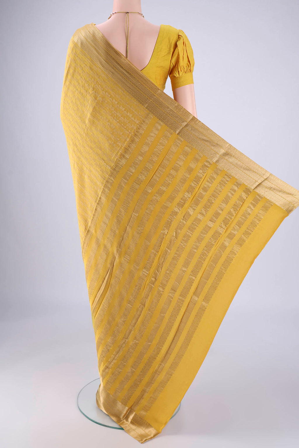 Flat view of Yellow Mysore Crepe Saree with Zari Brocade on the body and Zari Border. 