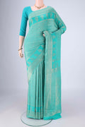 Turquoise Mysore Crepe Saree with Zari Brocade on the body and Zari Border.  displayed on a mannequin