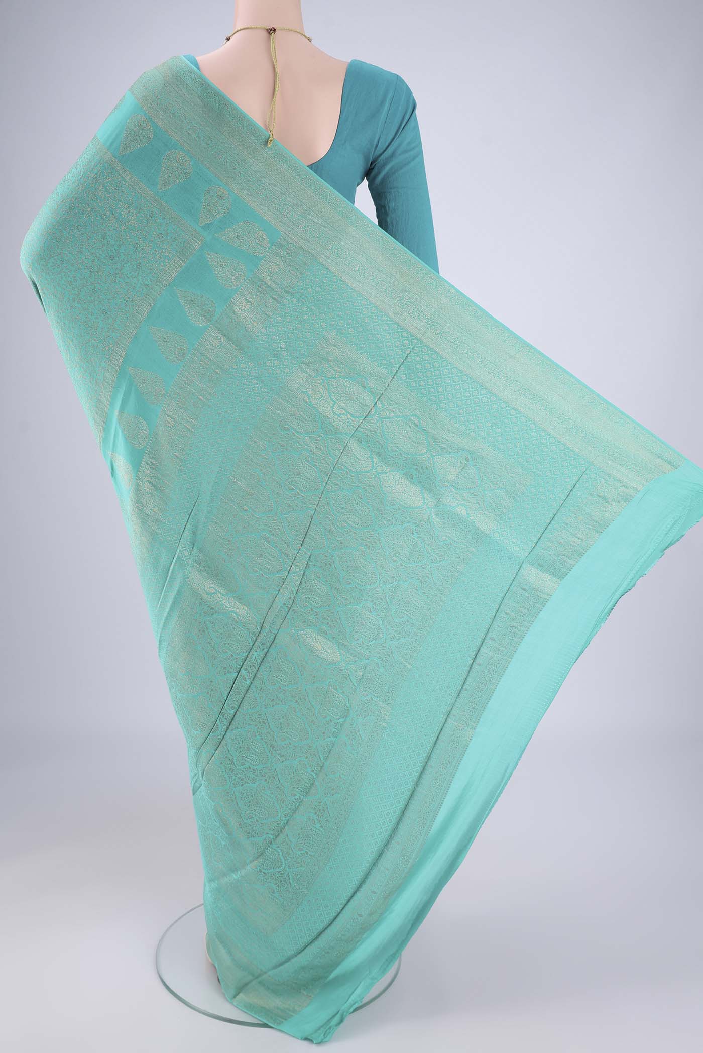 Flat view of Turquoise Mysore Crepe Saree with Zari Brocade on the body and Zari Border. 