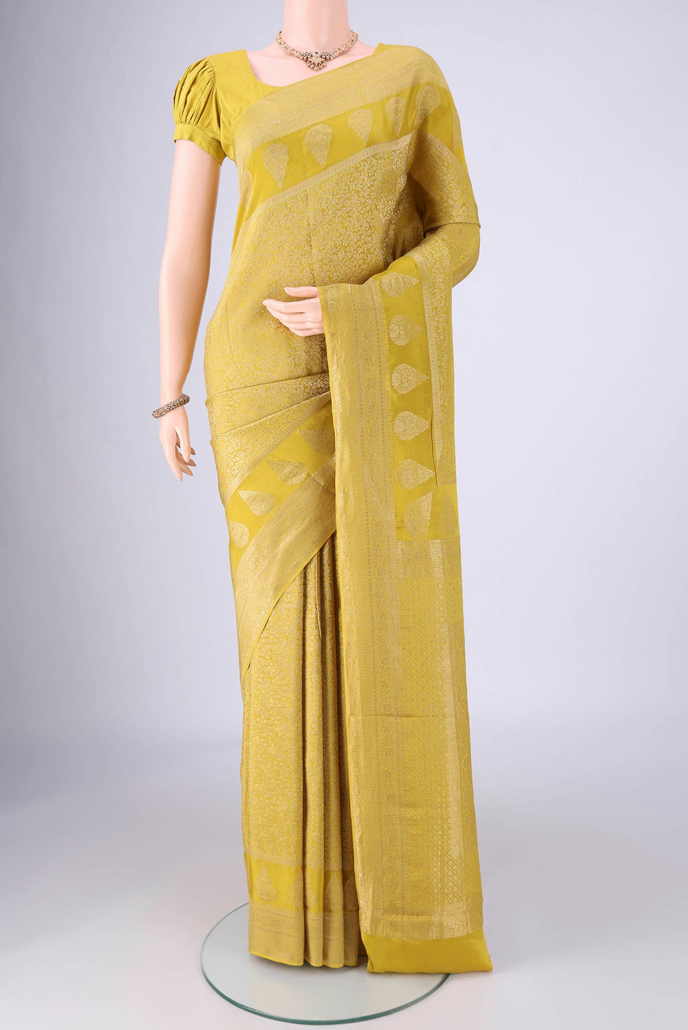 Acid Green Mysore Crepe Saree with Zari Brocade on the body and Zari Border.  displayed on a mannequin