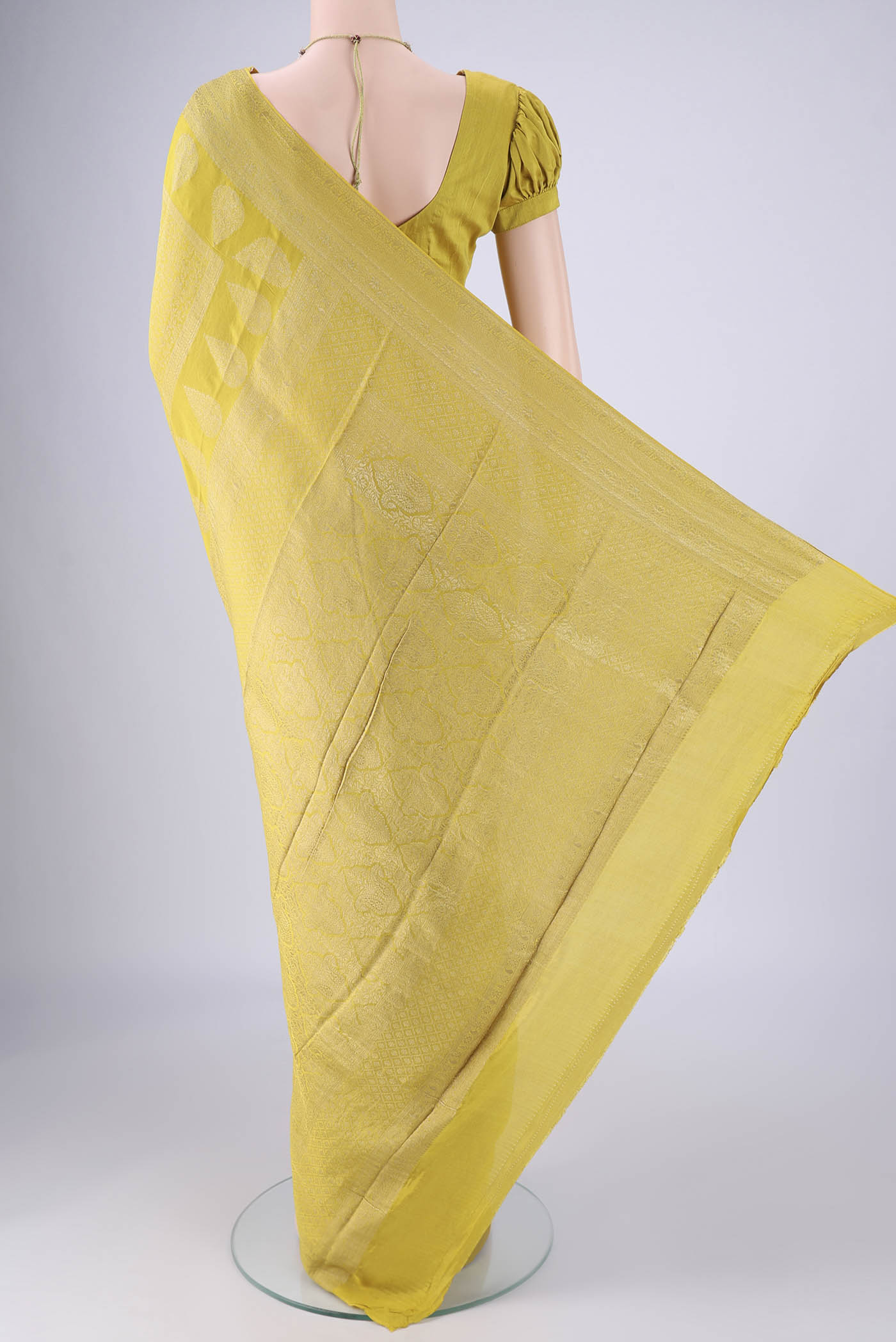 Flat view of Acid Green Mysore Crepe Saree with Zari Brocade on the body and Zari Border. 